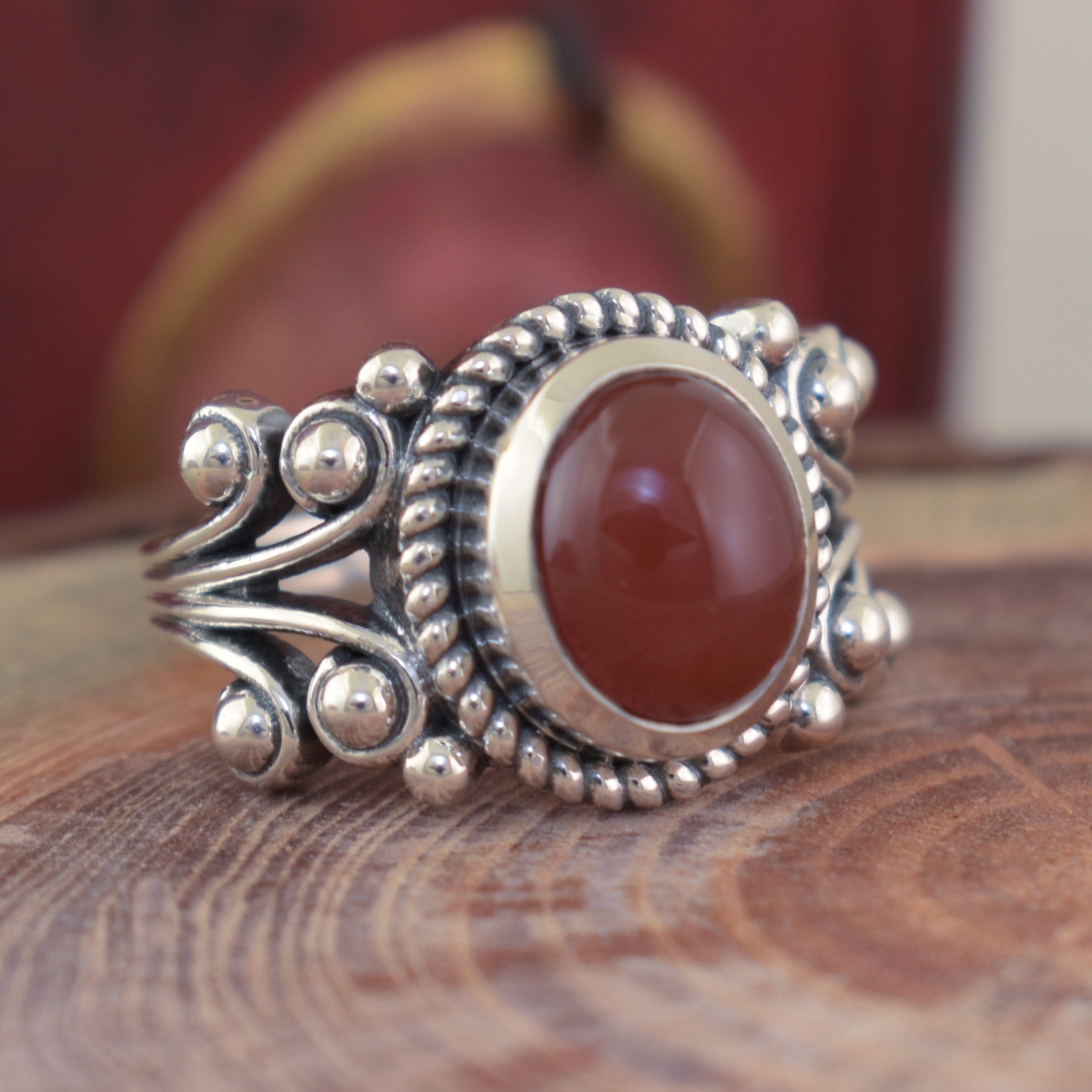 Sterling silver statement ring with silver swirls on the band