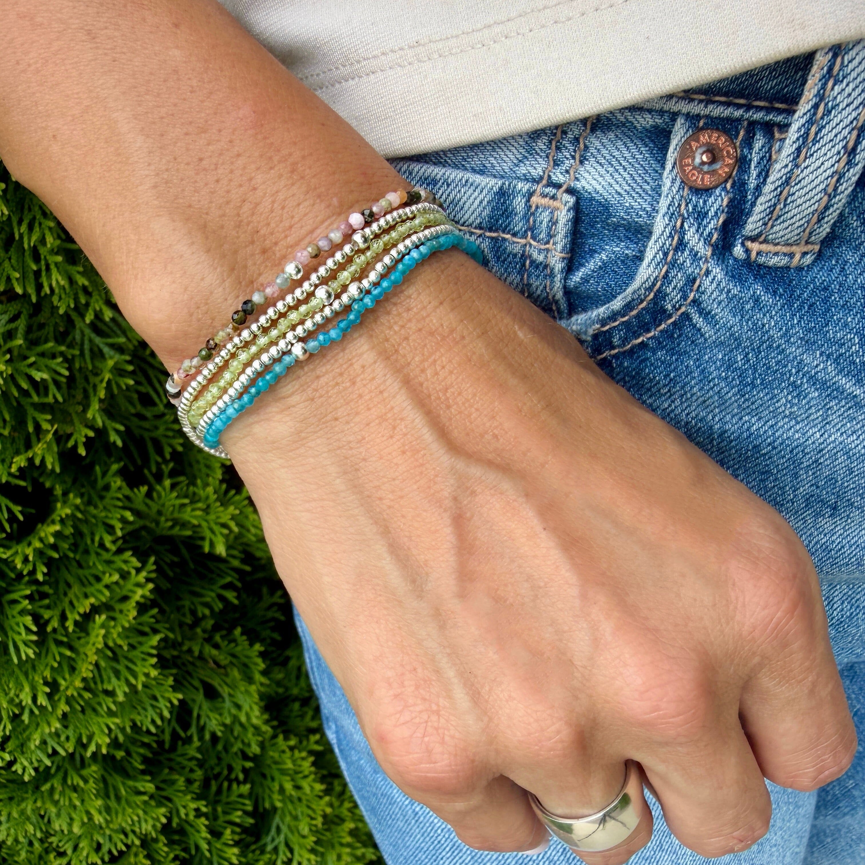 dainty stack bracelets with various stone colors