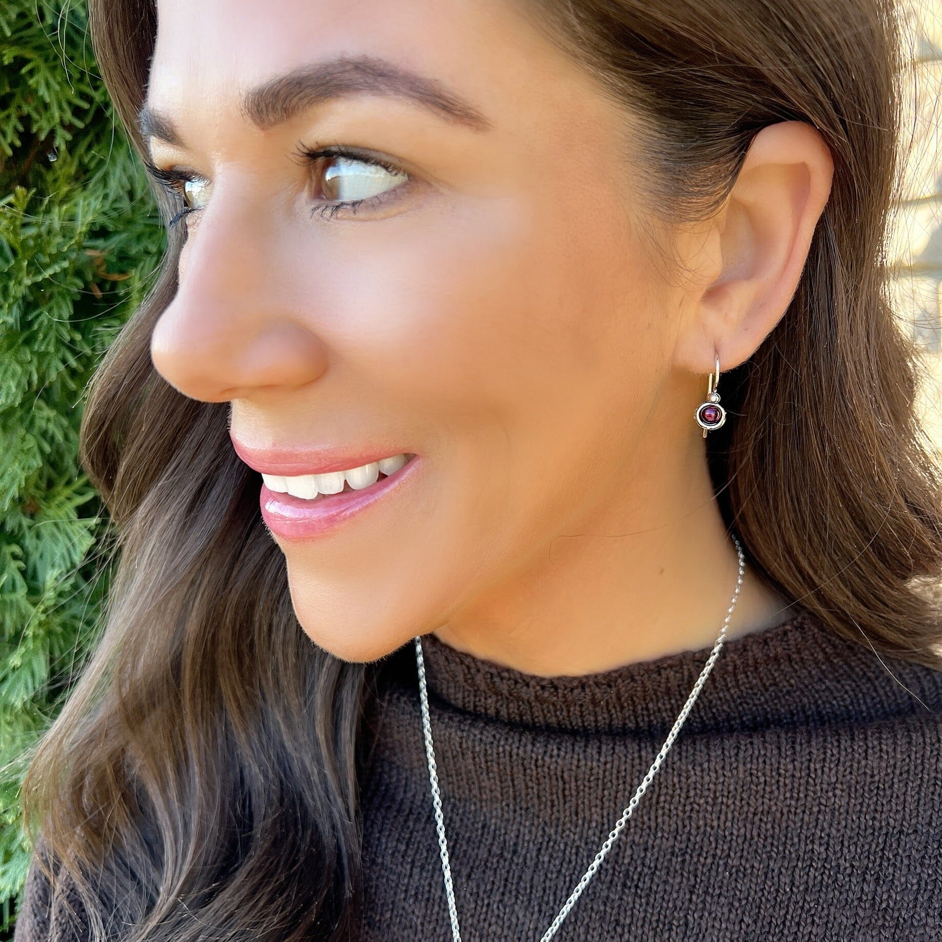 Secure French back earrings with a garnet stone 