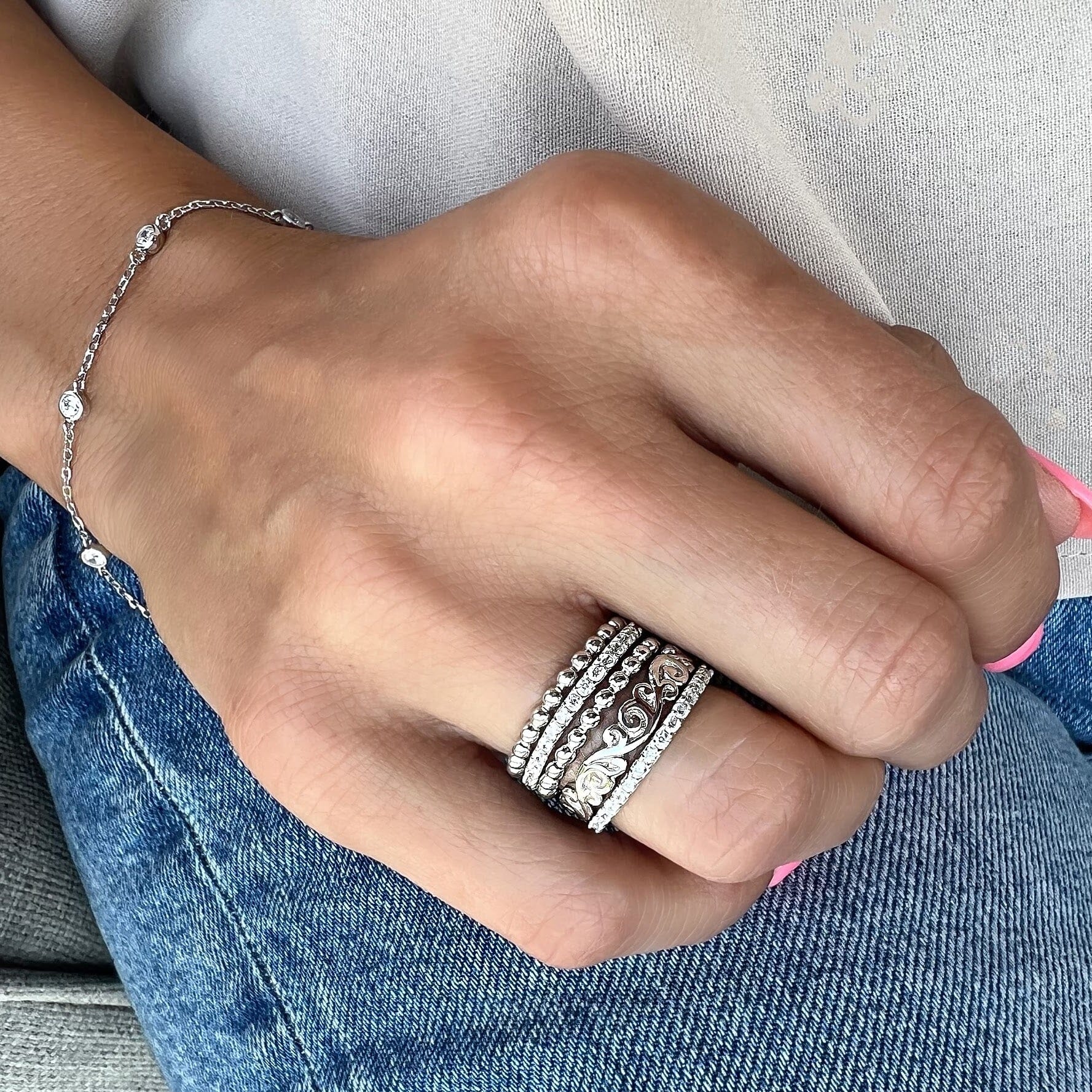 Scroll'n Bliss stack rings paired with dainty Starlight Bracelet