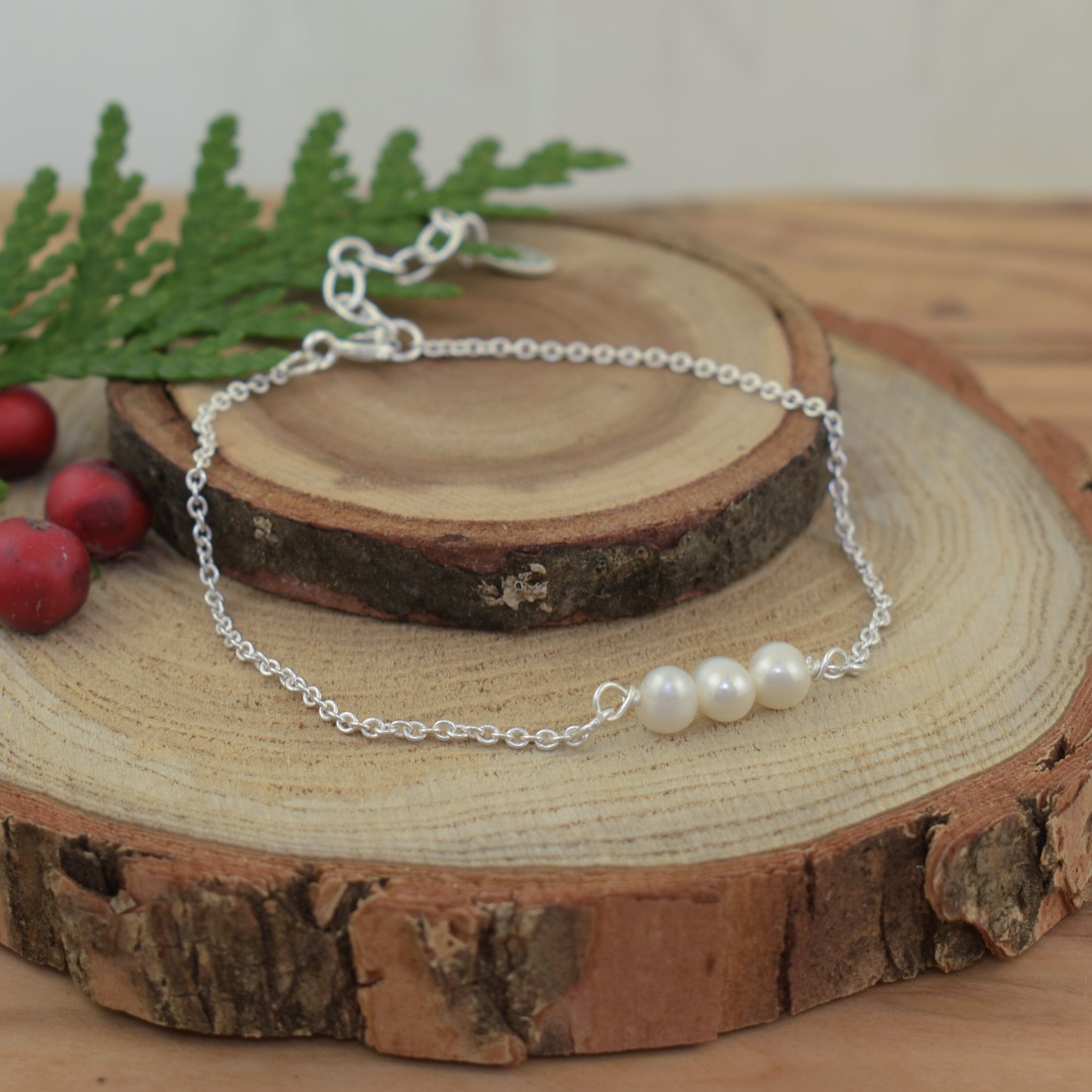 delicate silver bracelet featuring three freshwater pearls