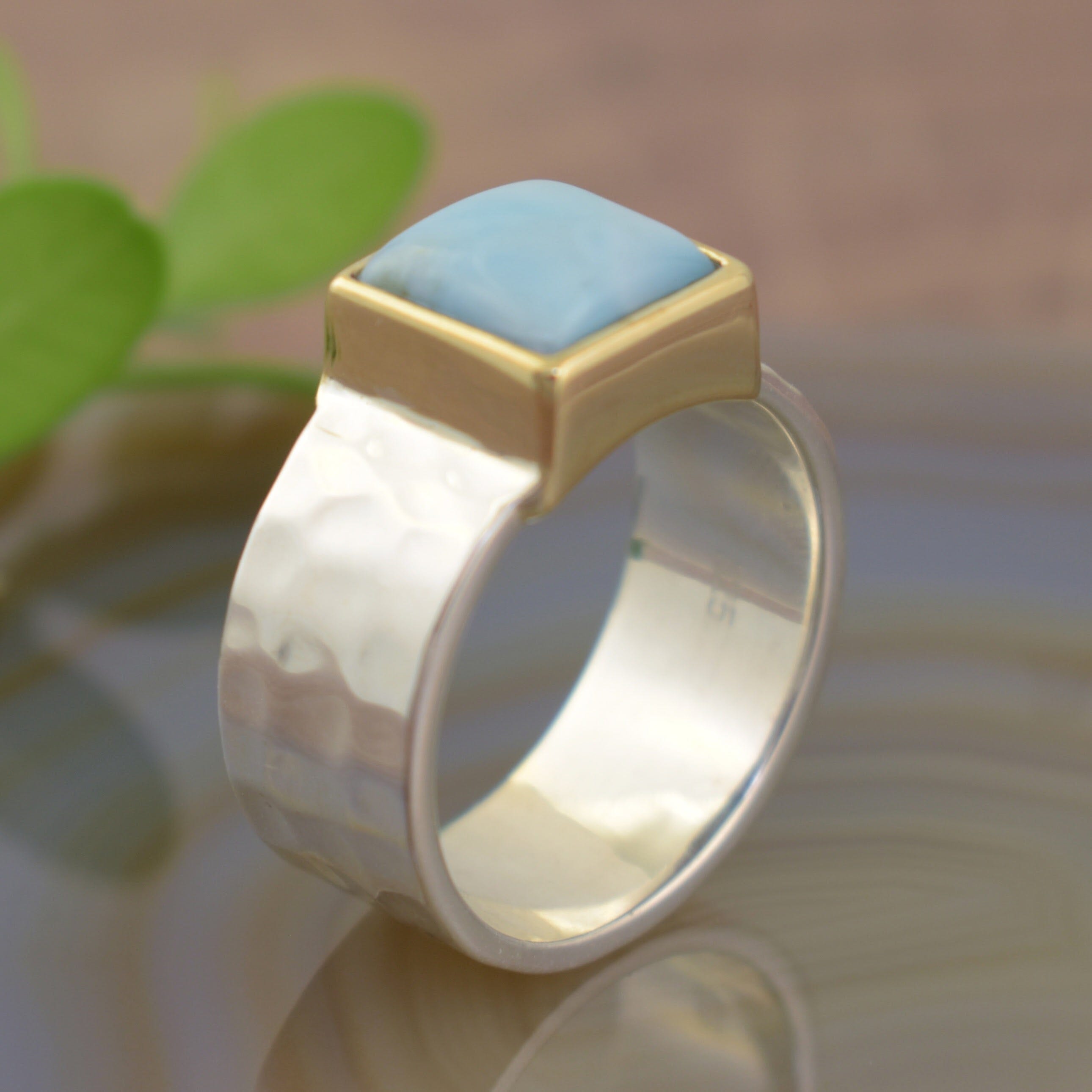Larimar bezel set stone on a wide band ring