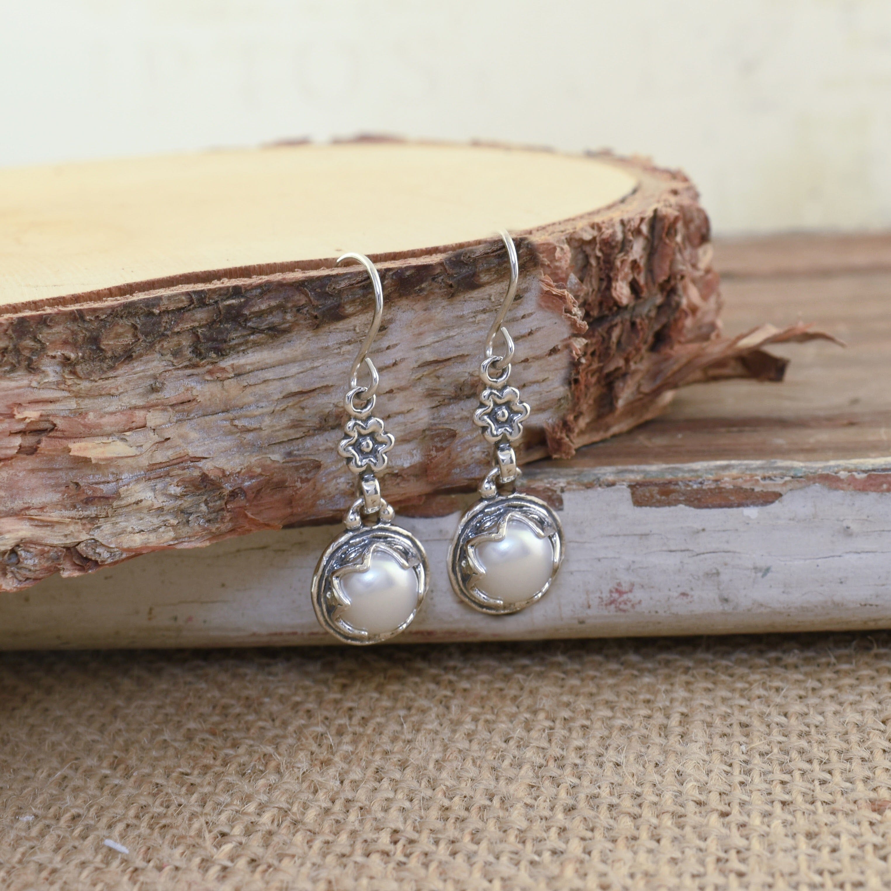 Sterling silver and white freshwater pearl earrings with tiny flower accent