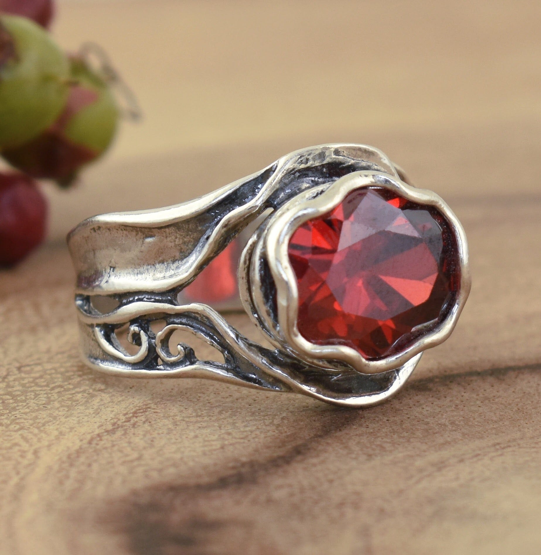 designer silver ring featuring sedona red cz