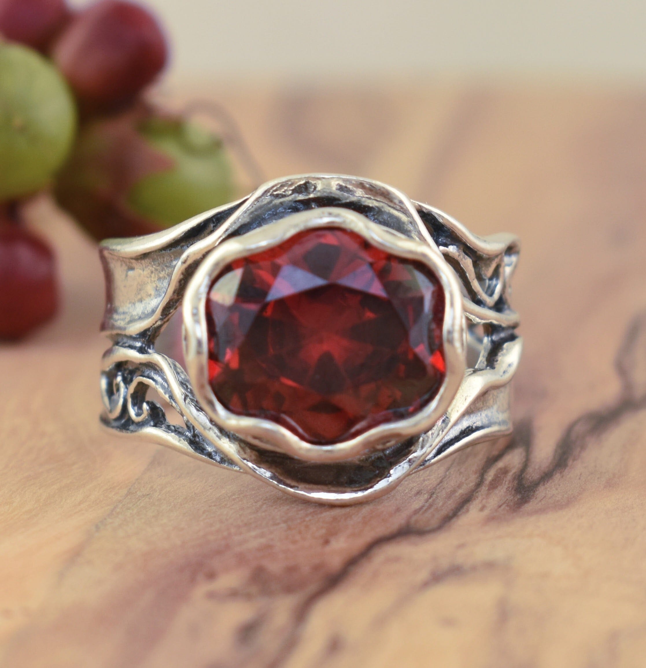 oxidized silver ring featuring sedona red cz set in a wavy bezel
