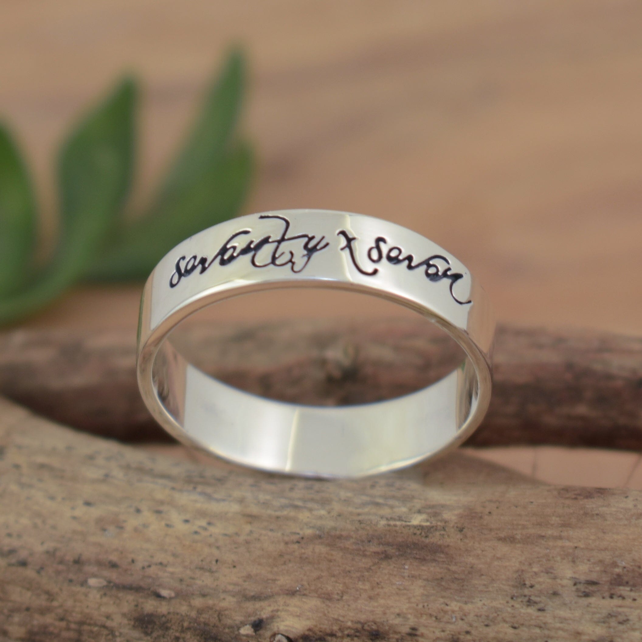 thin sterling silver ring hand-stamped with "Seventy X Seven"