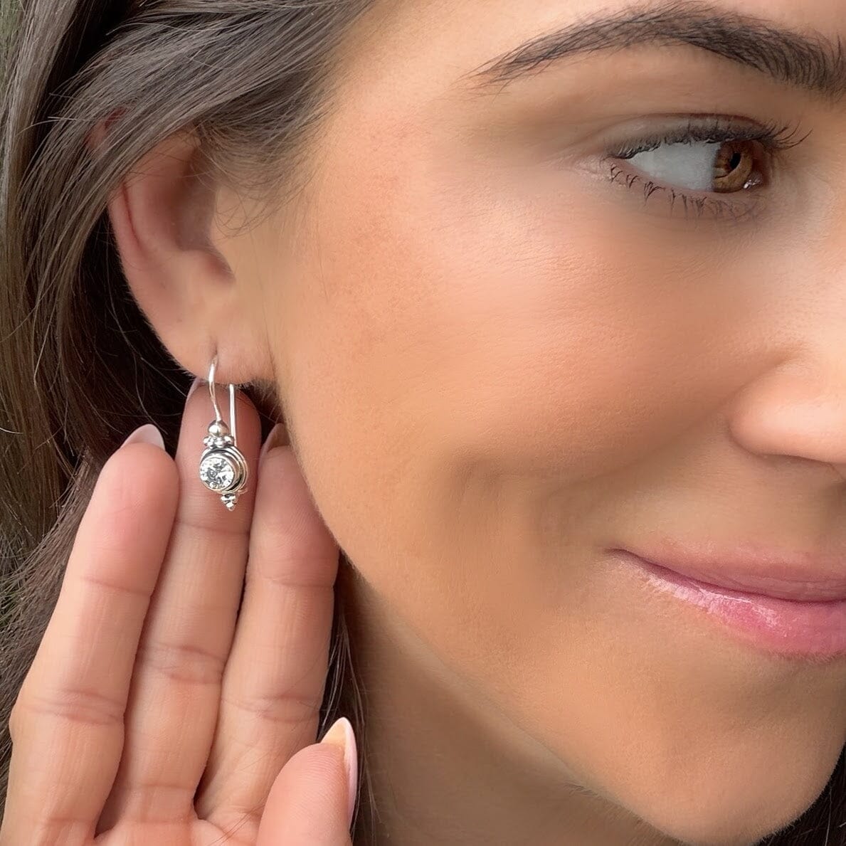 Sterling silver earrings with a bezel set stone