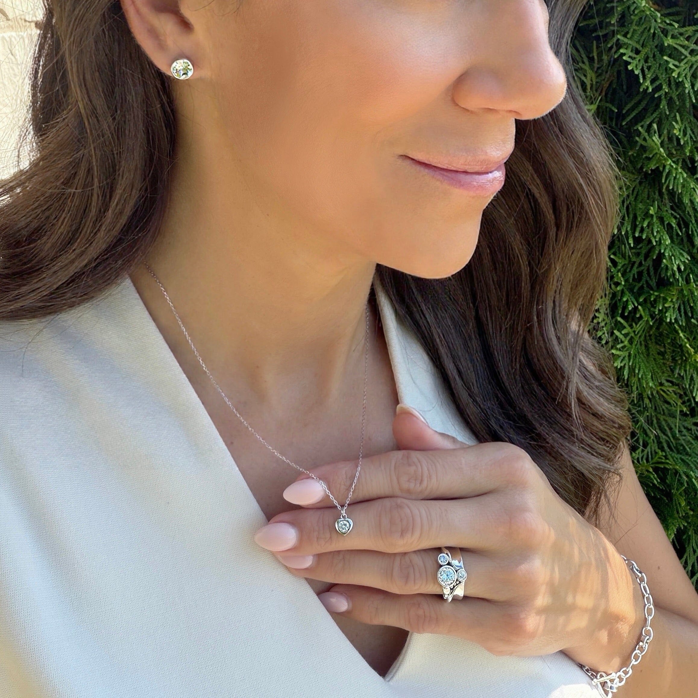 minimalist style heart shaped necklace with a clear gemstone center