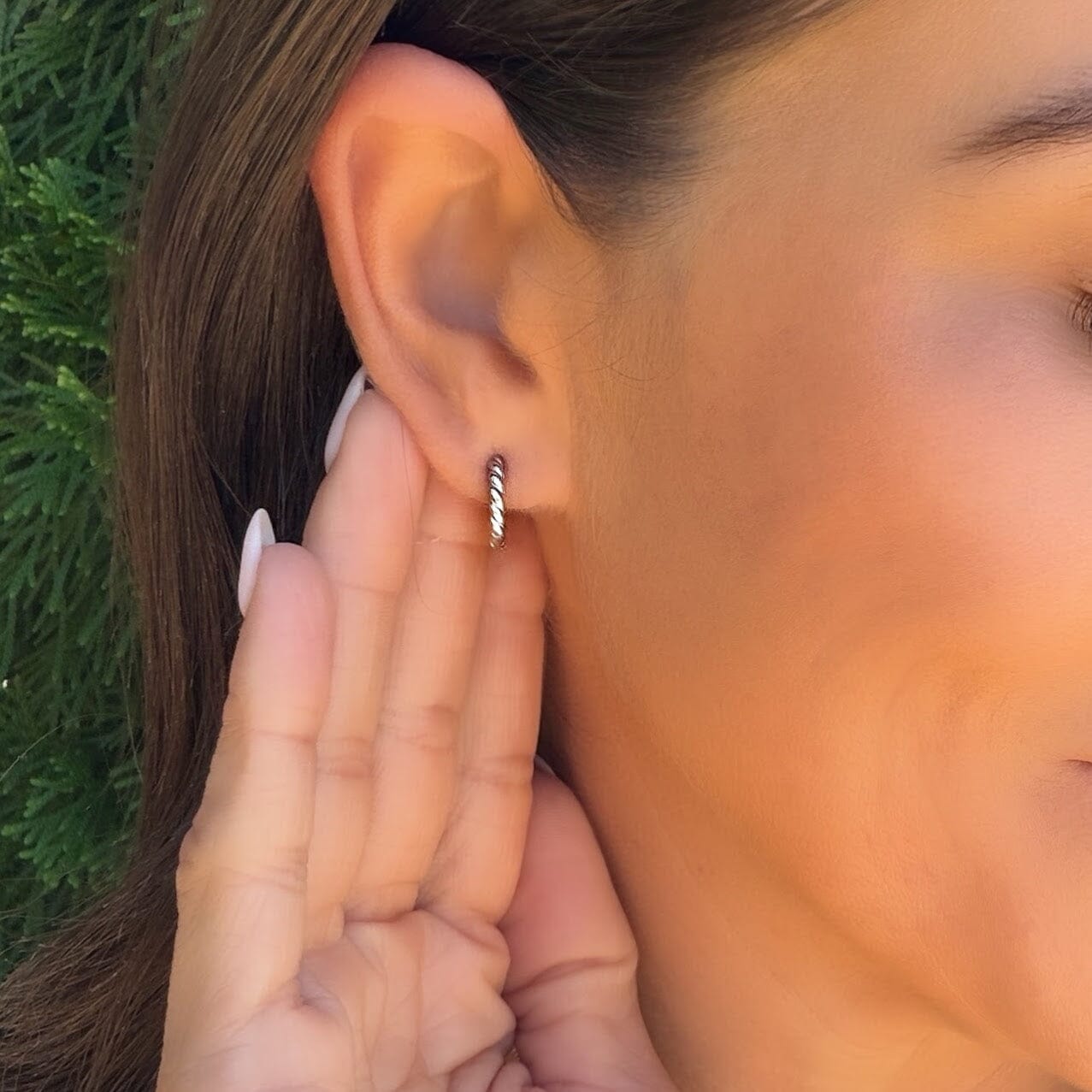 silver huggie earrings with a twist design