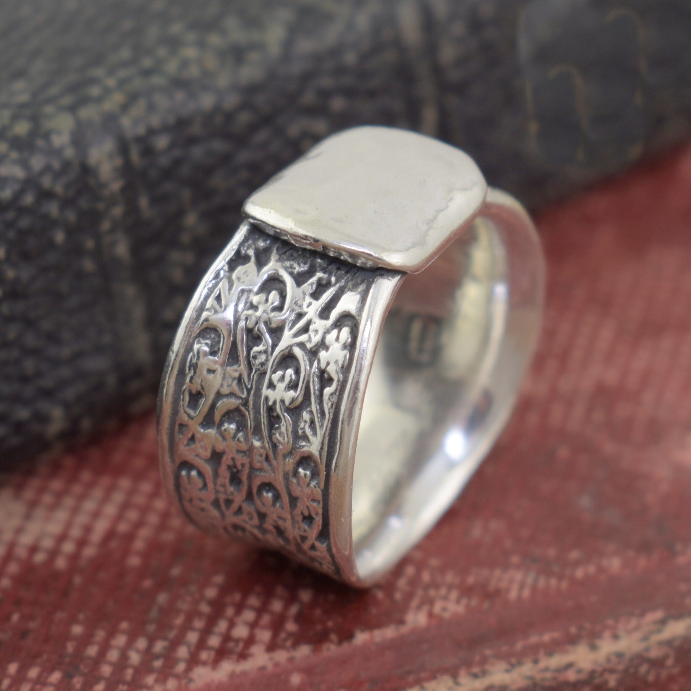 .925 wide band ring with floral designs on the band