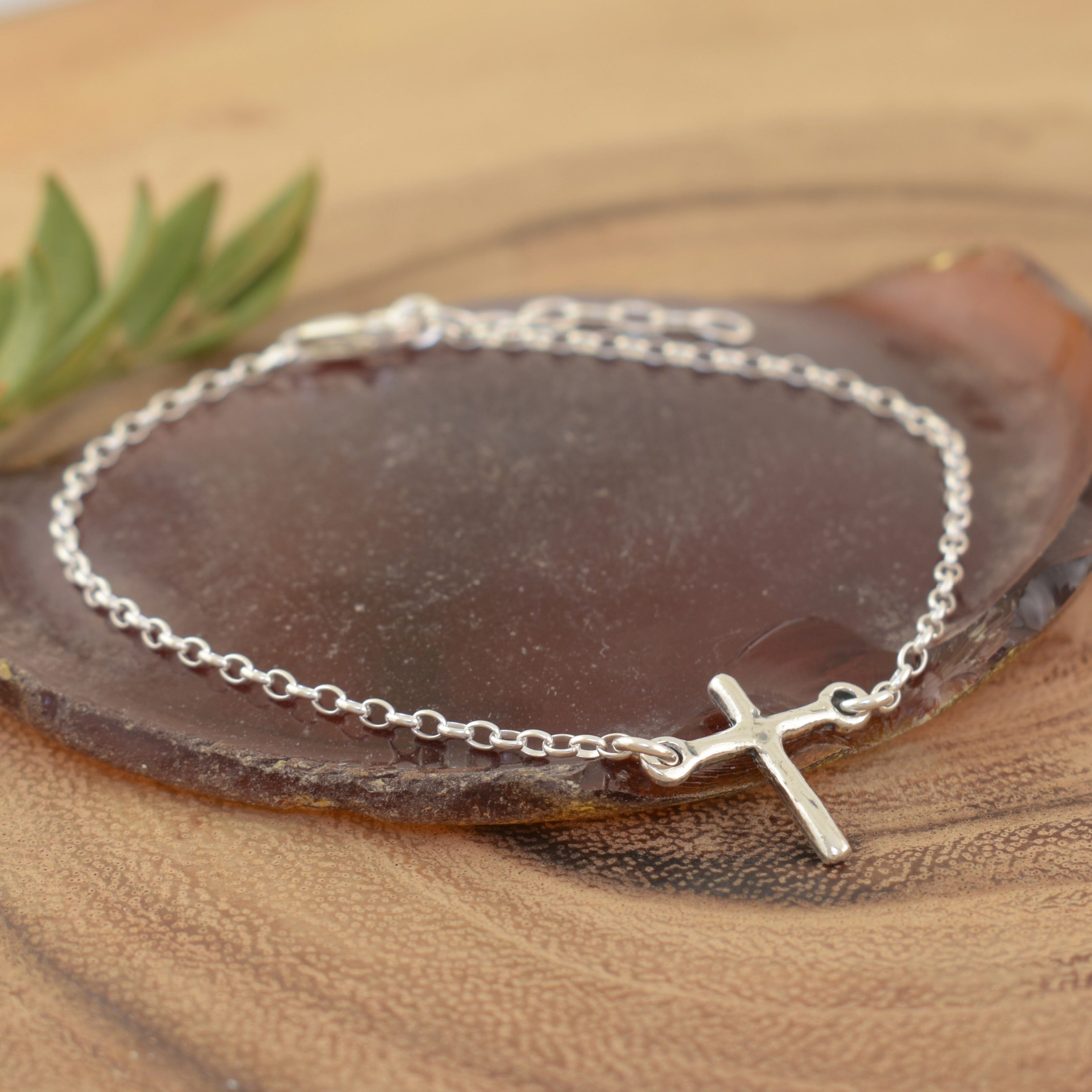 Sterling silver bracelet featuring a cross with a link chain