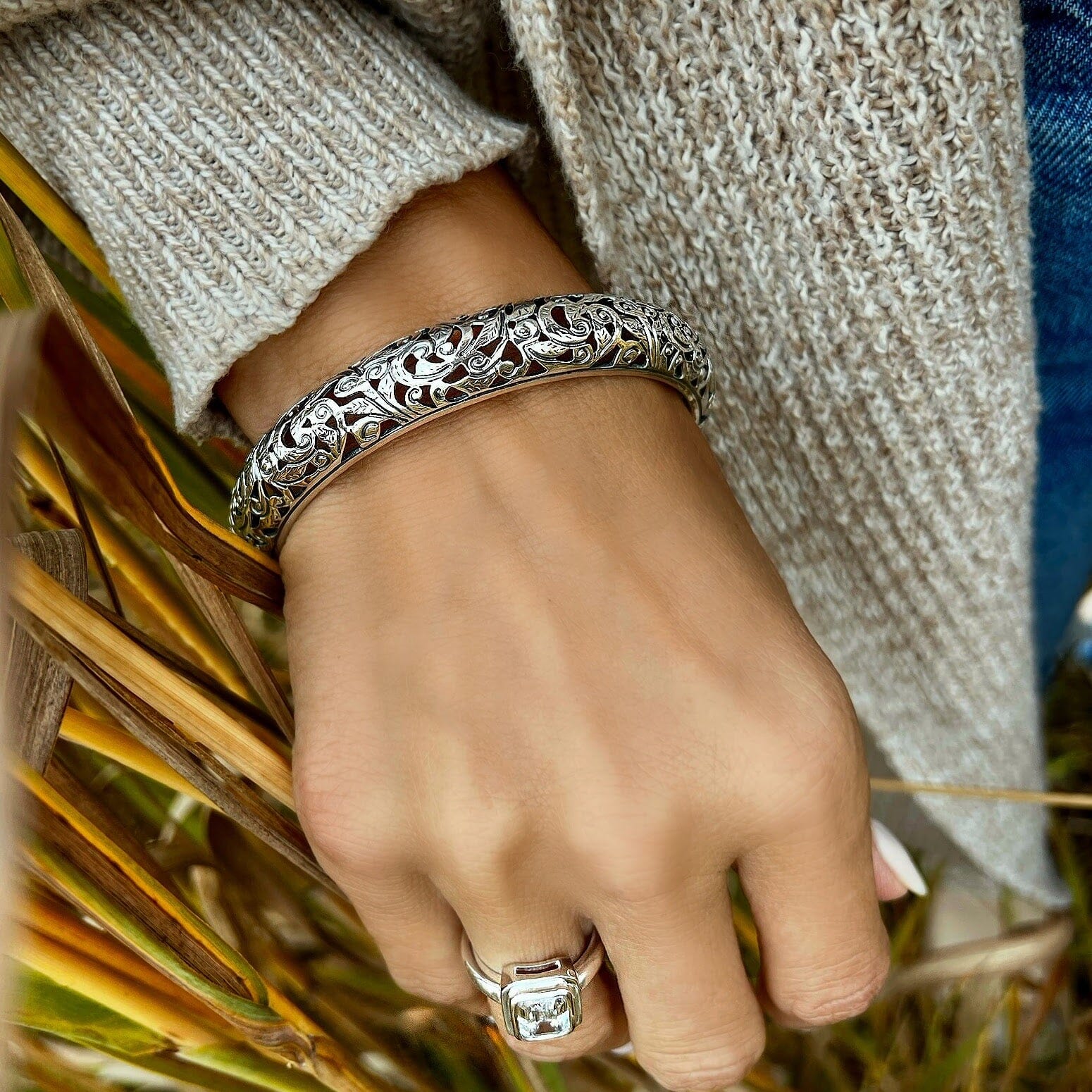 .925 sterling silver bangle with a cut-out swirl design