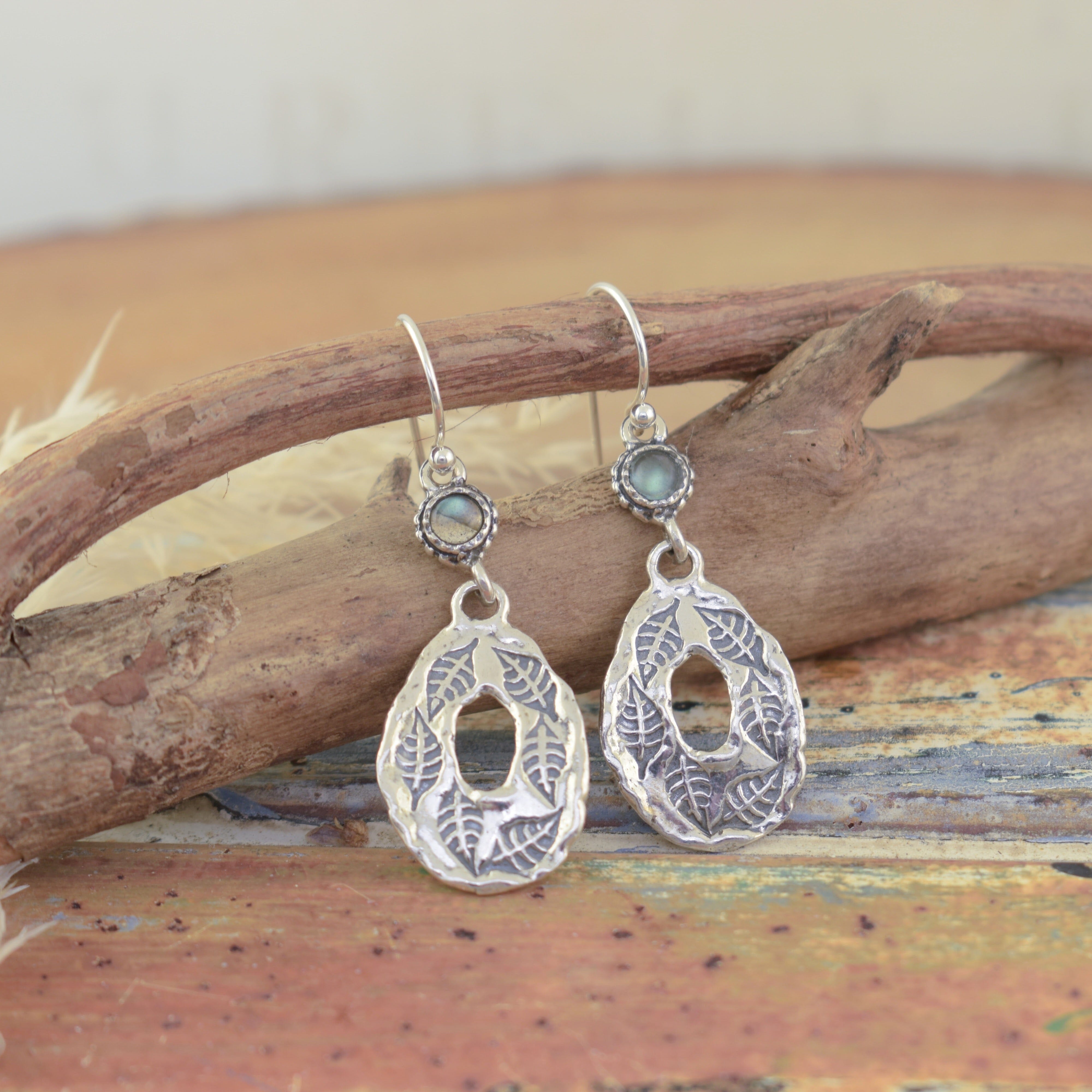 Labradorite stone attached to a leaf stamped dangle earrings