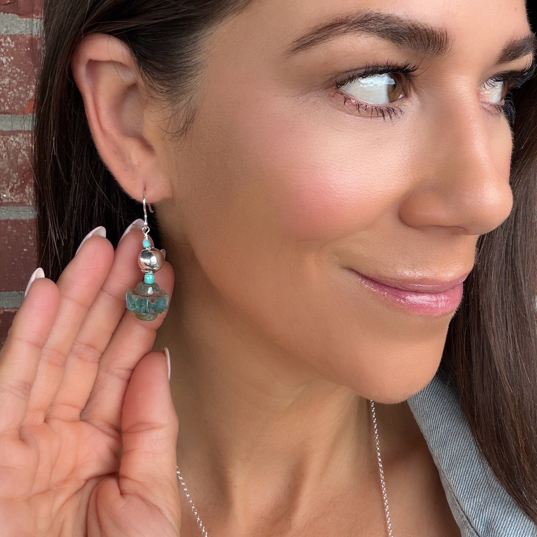 sterling silver earrings featuring silver and turquoise beaded accents and faceted glass