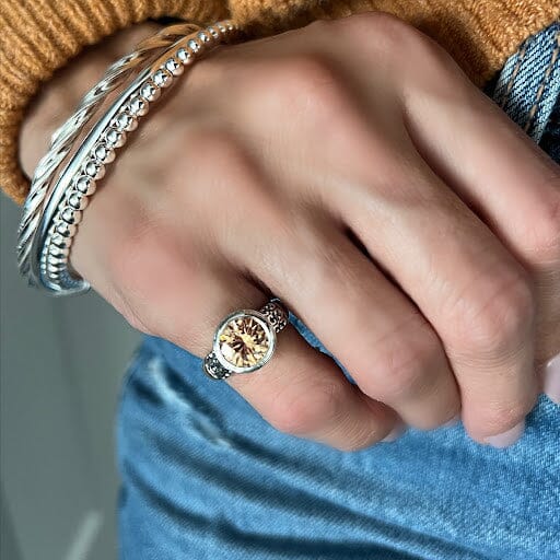 sterling silver ring with a golden cubic zirconium stone in the center