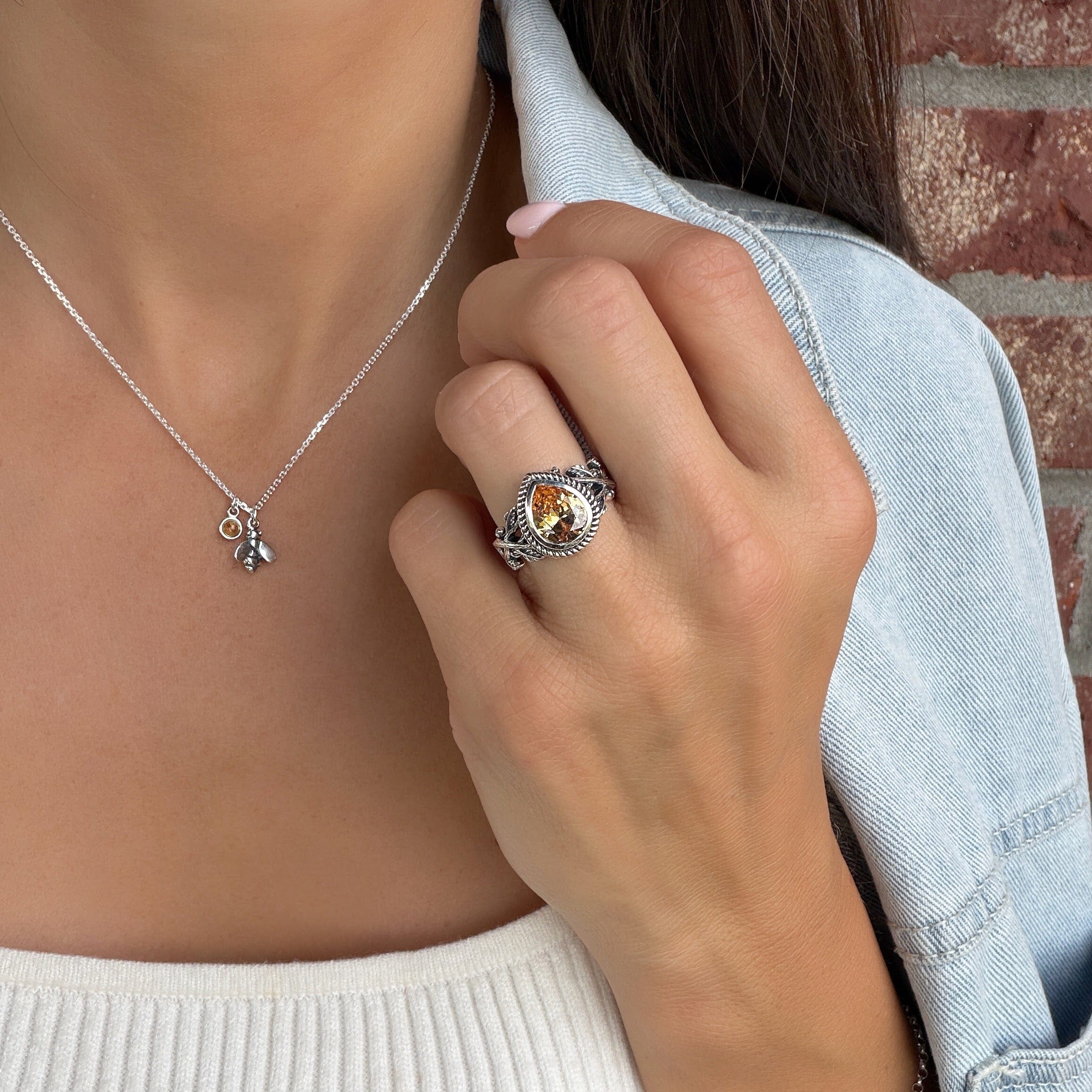 vine textured ring with a golden cz bezel set in a frame with a ridge texture
