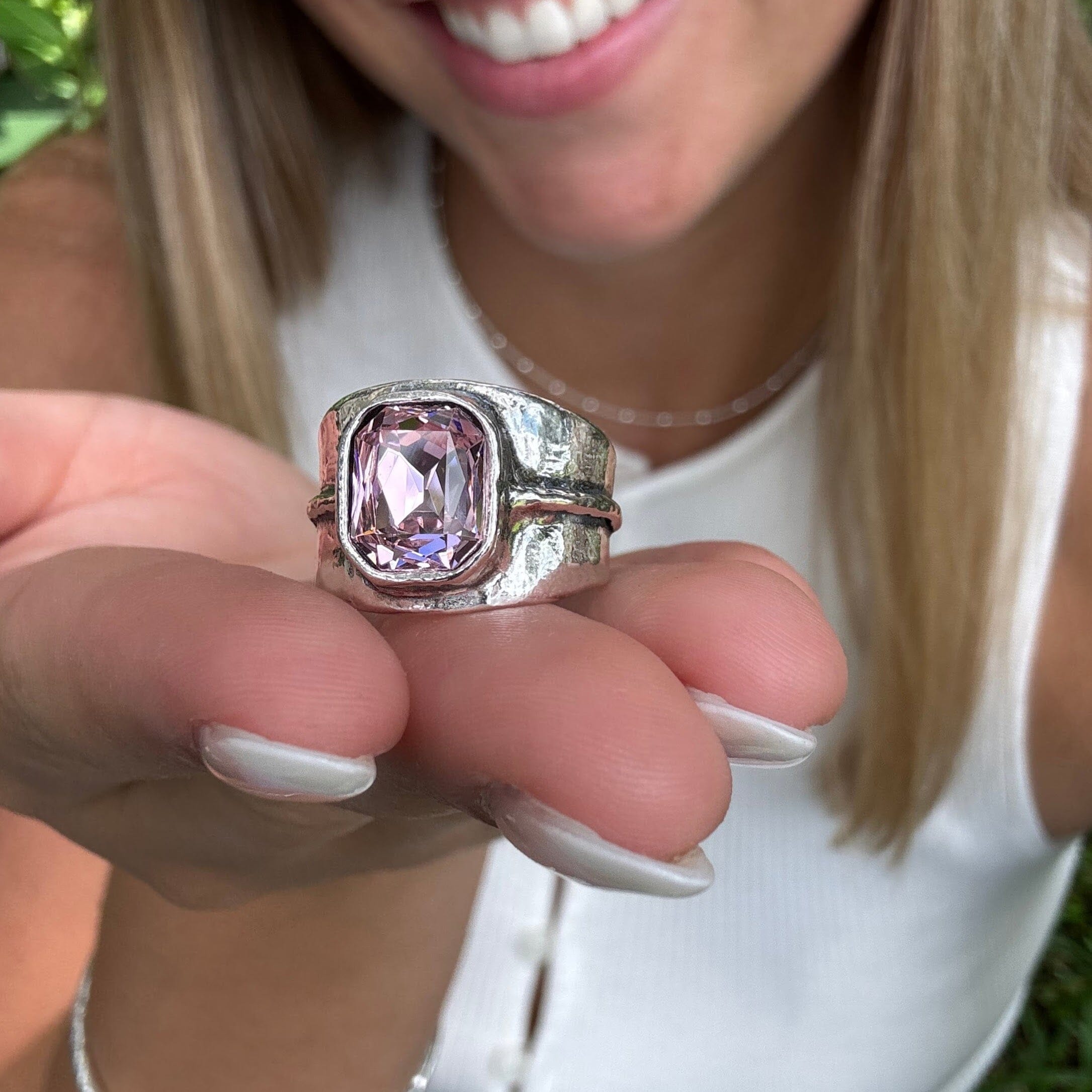 silver designer ring bezel set with a soft pink center stone