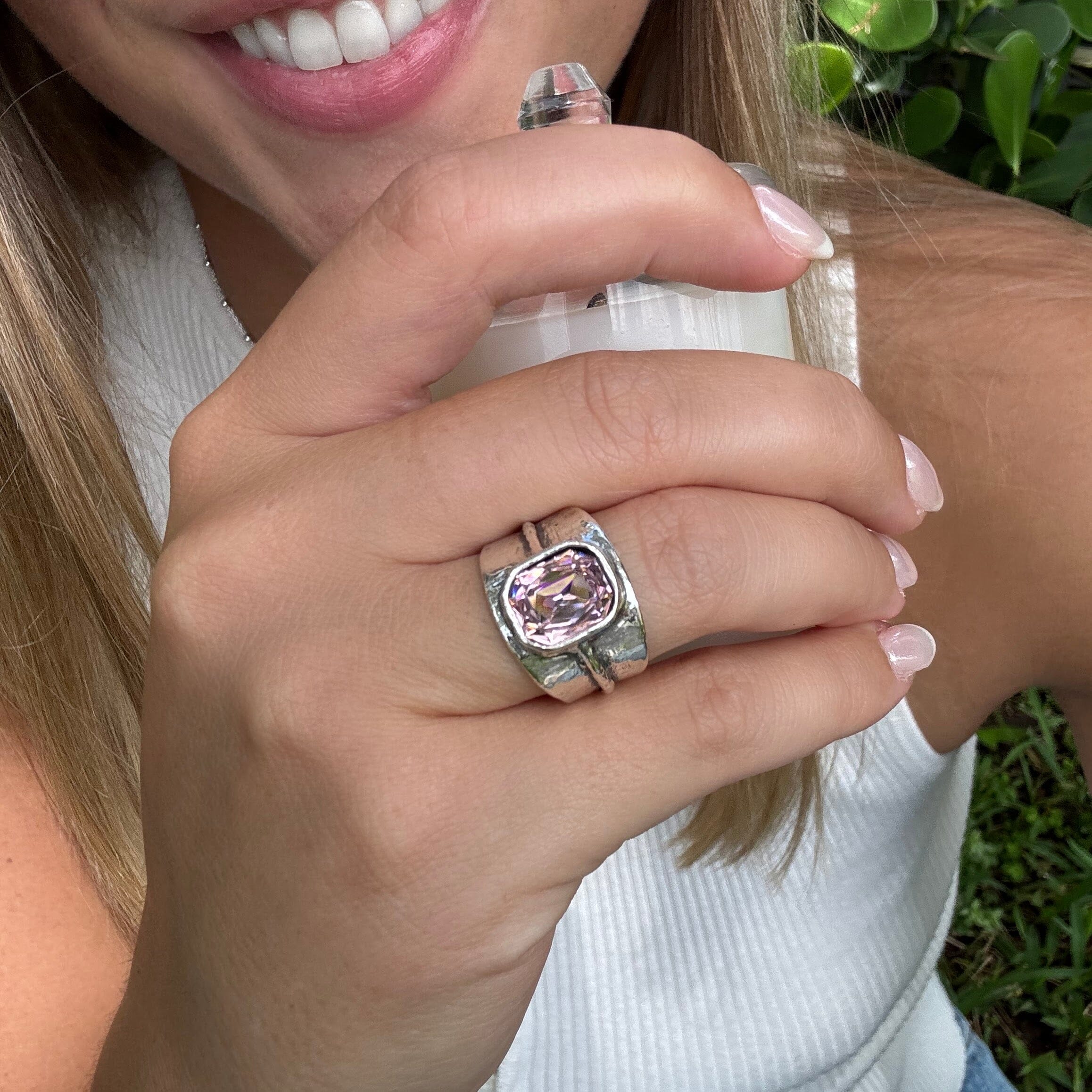 wide sterling silver ring with a cushion-cut pink stone