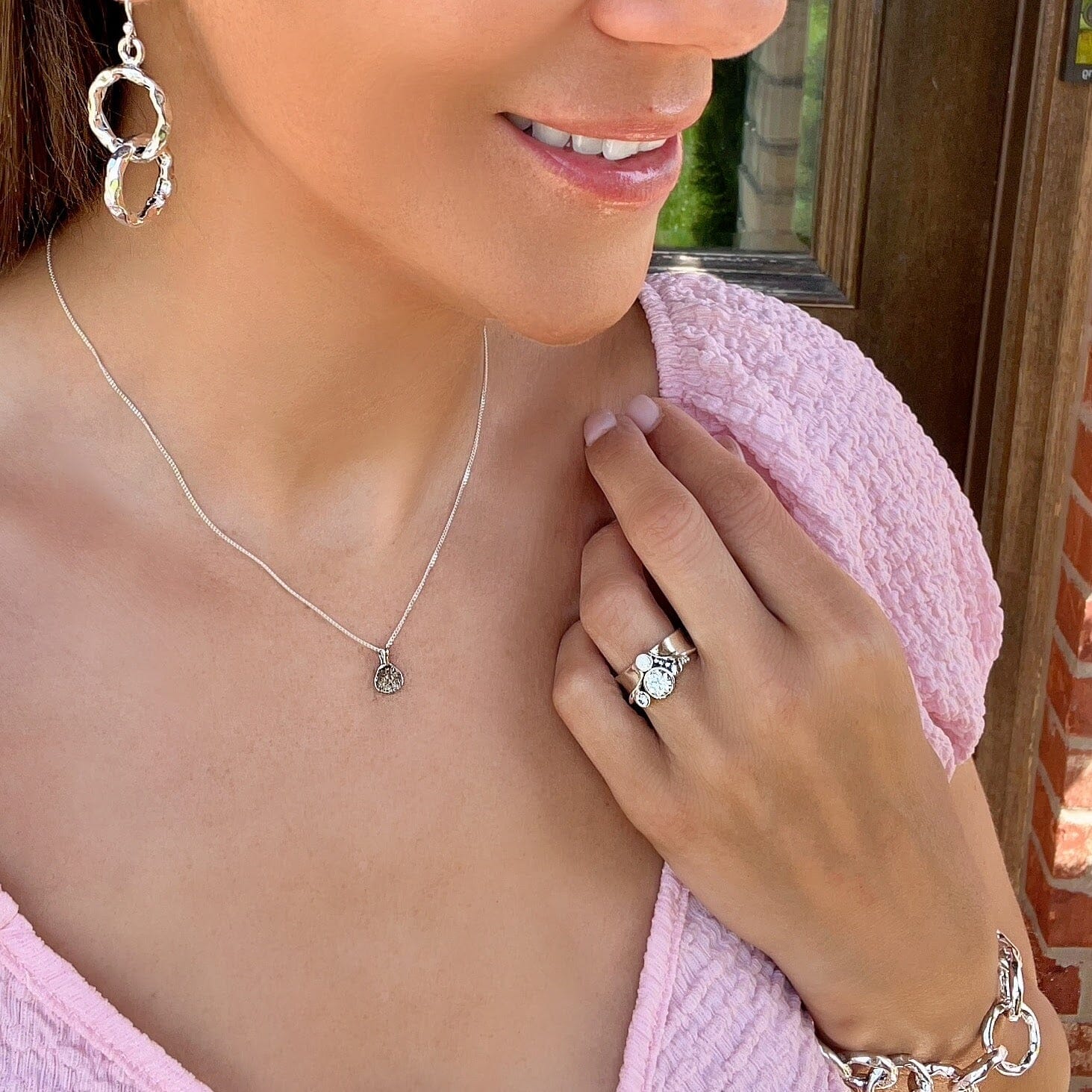 Sweet Impression Necklace featuring a dainty, triangular hammered pendant in sterling silver