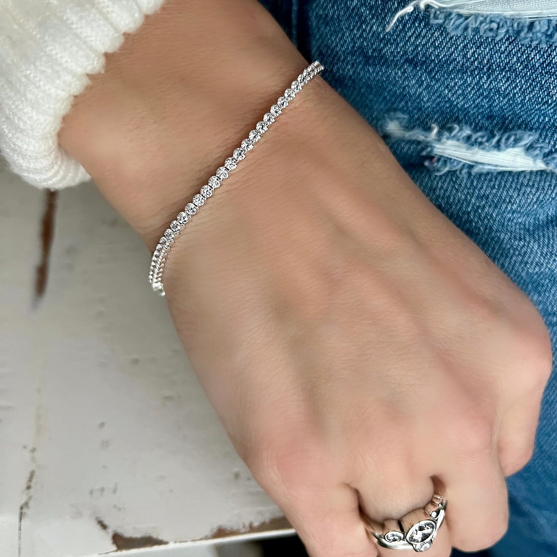 sterling silver tennis bracelet with CZ stones all around the bracelet.