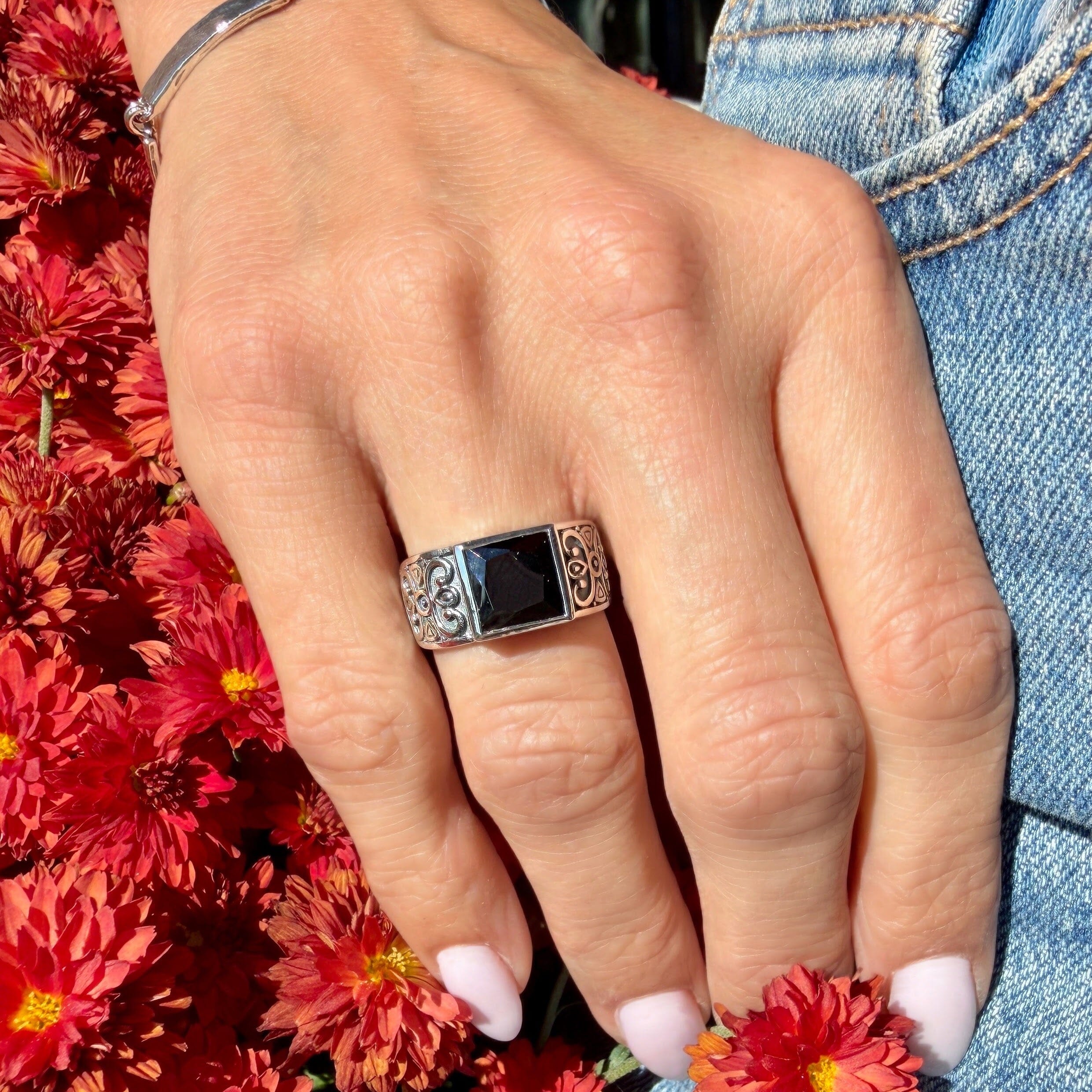 sterling silver ring with scroll-work and a square shaped black cz center stone