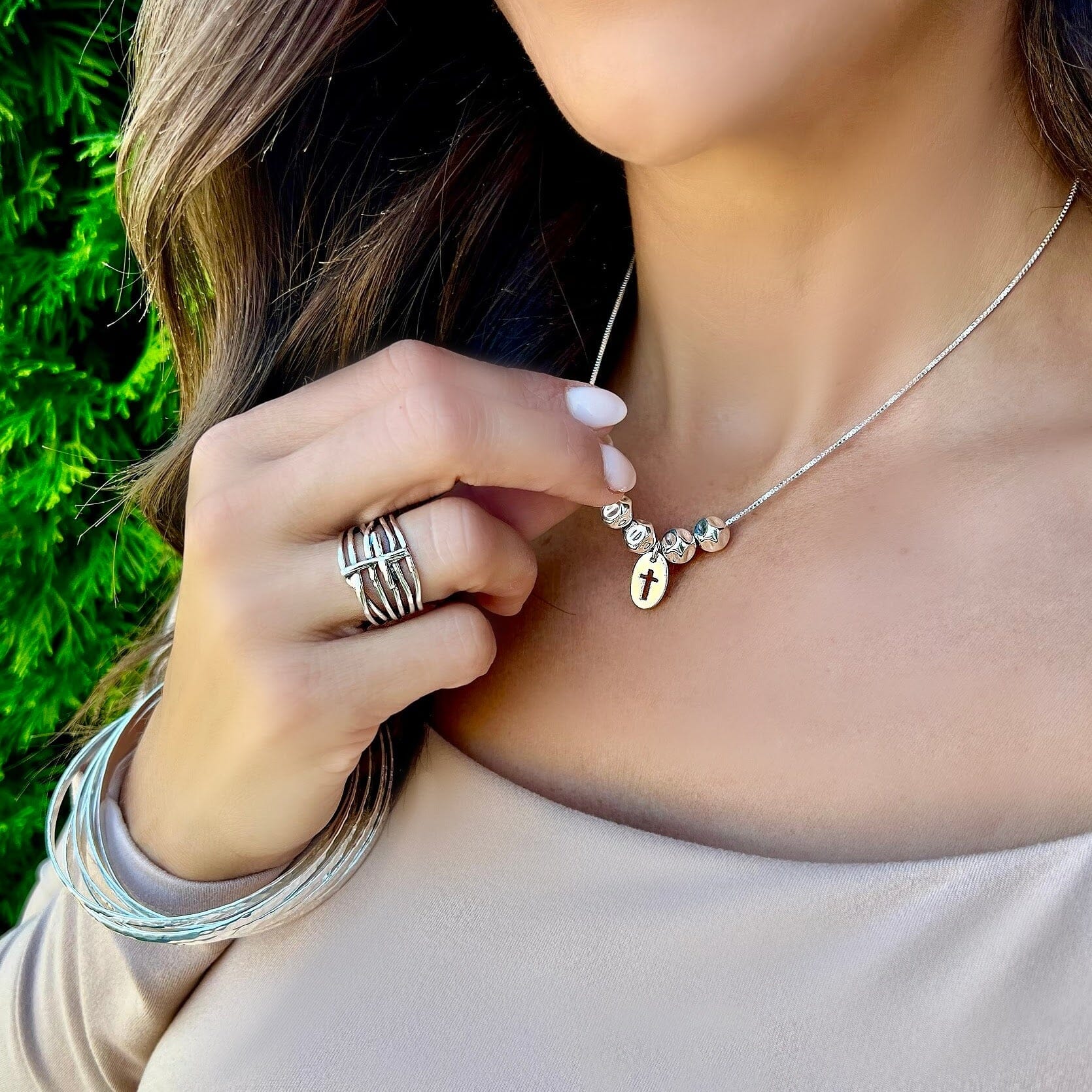 sterling silver bead necklace with a cut out cross in the center