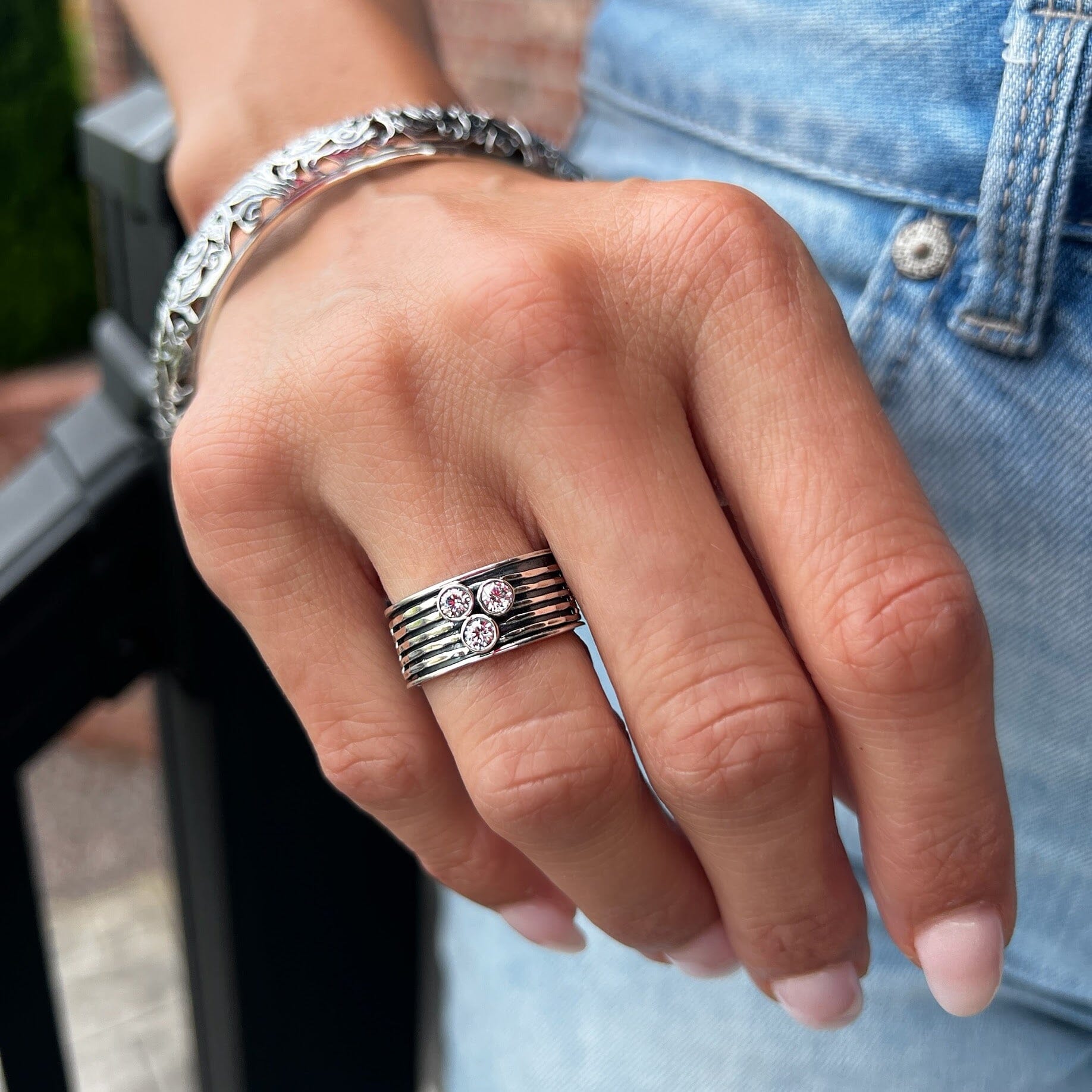 Handcrafted wide band ring with a spinning center