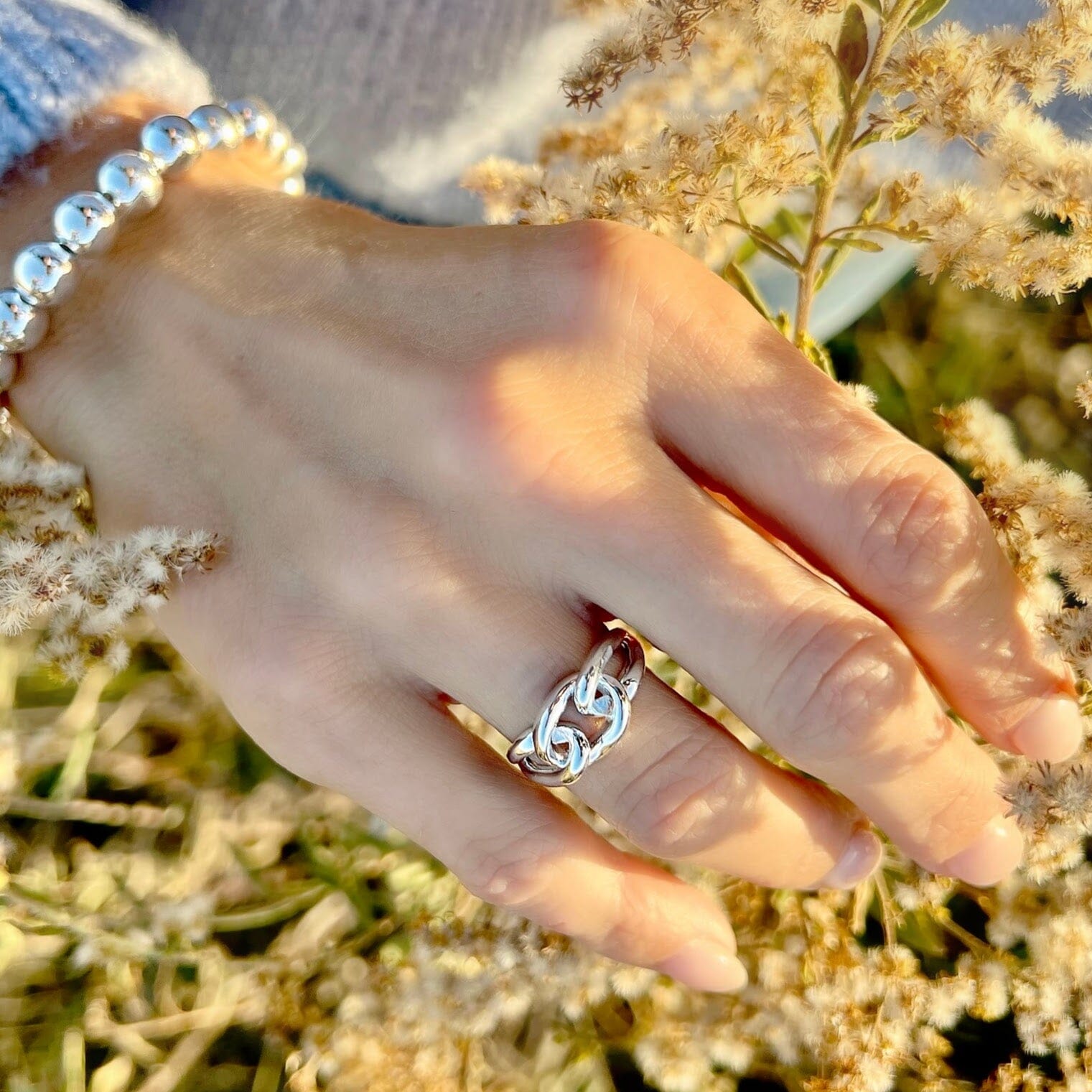 silver ring with three knots