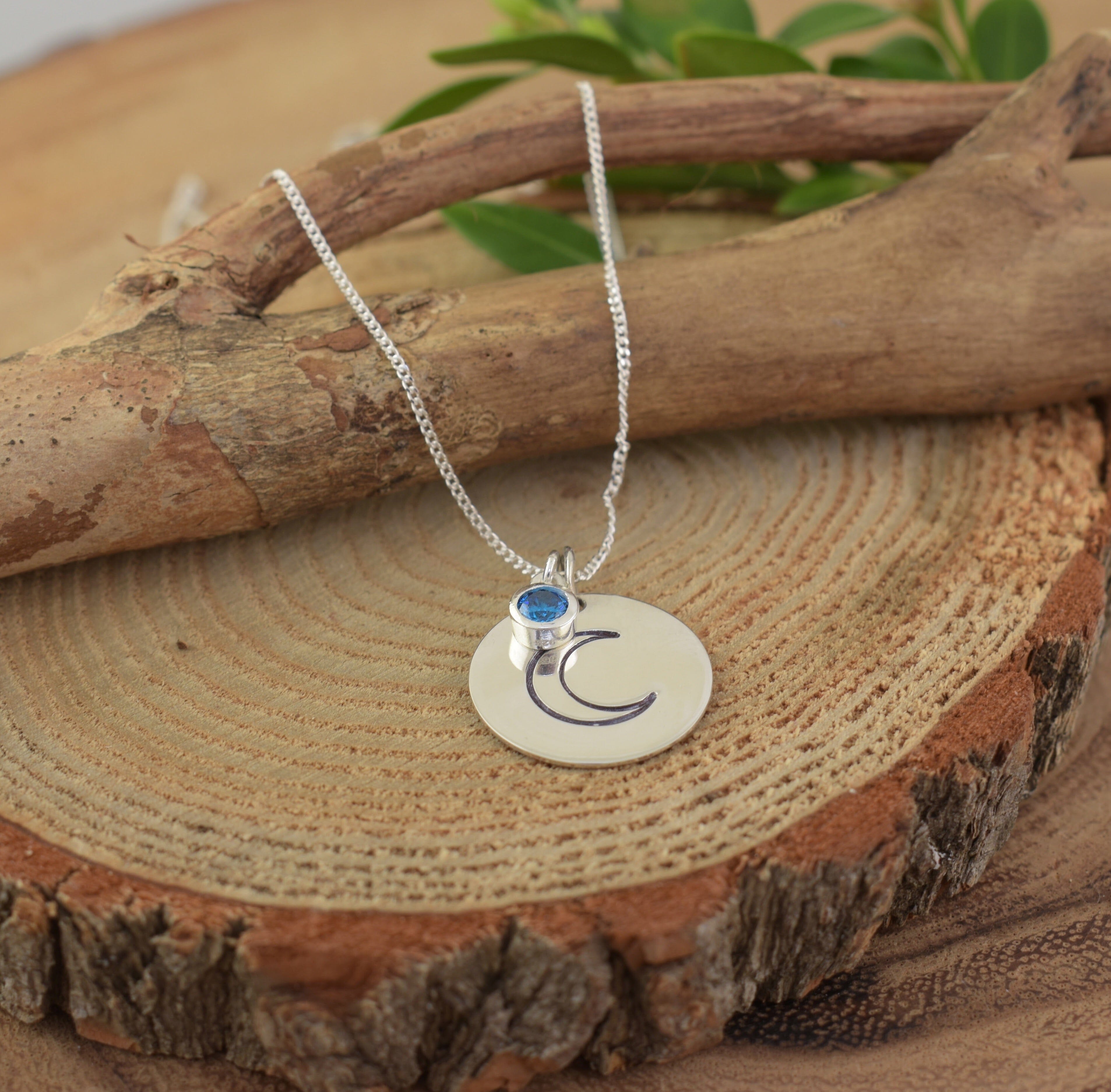 Sterling silver necklace featuring hand stamped half moon pendant with a birthstone