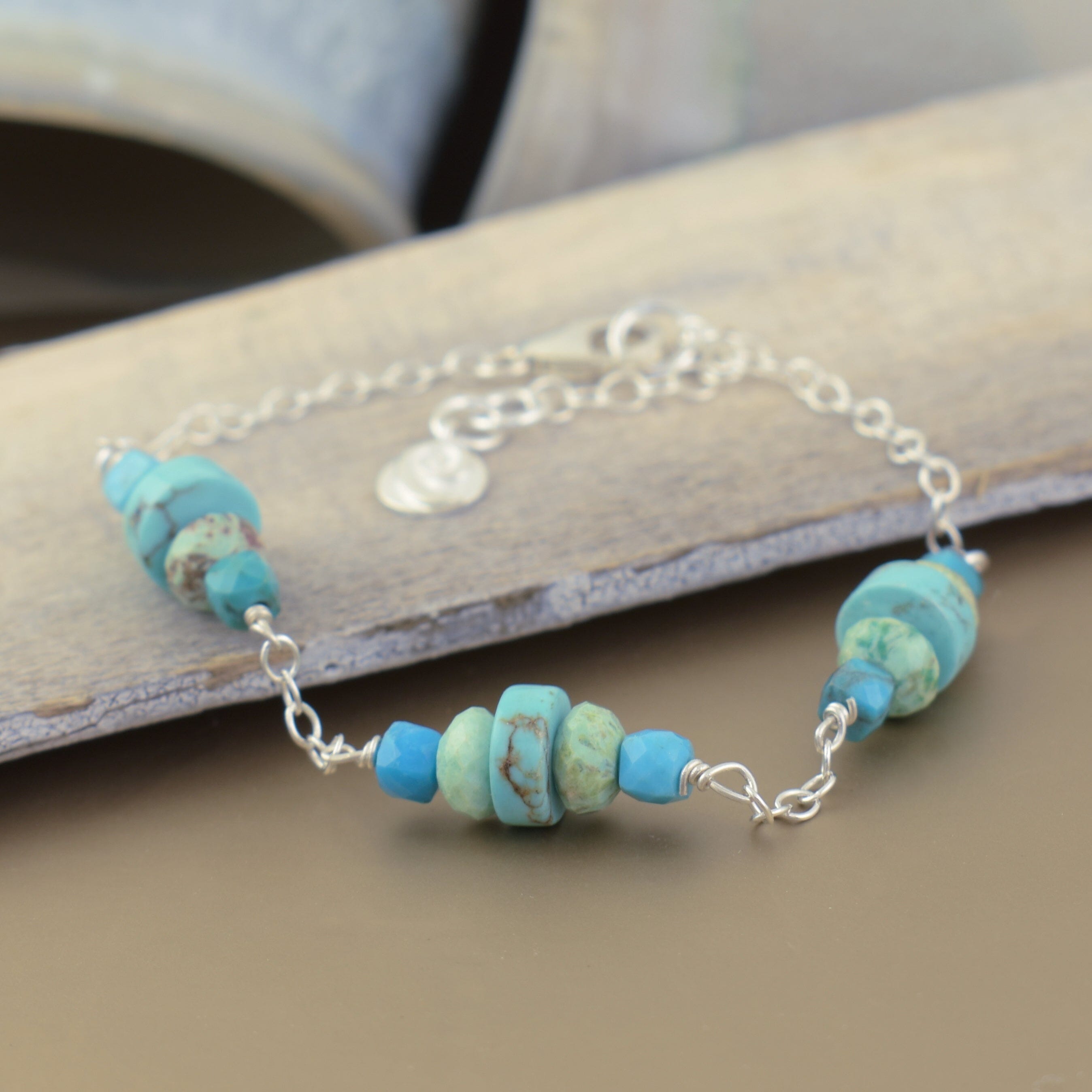 silver adjustable bracelet featuring various colors of turquoise stones