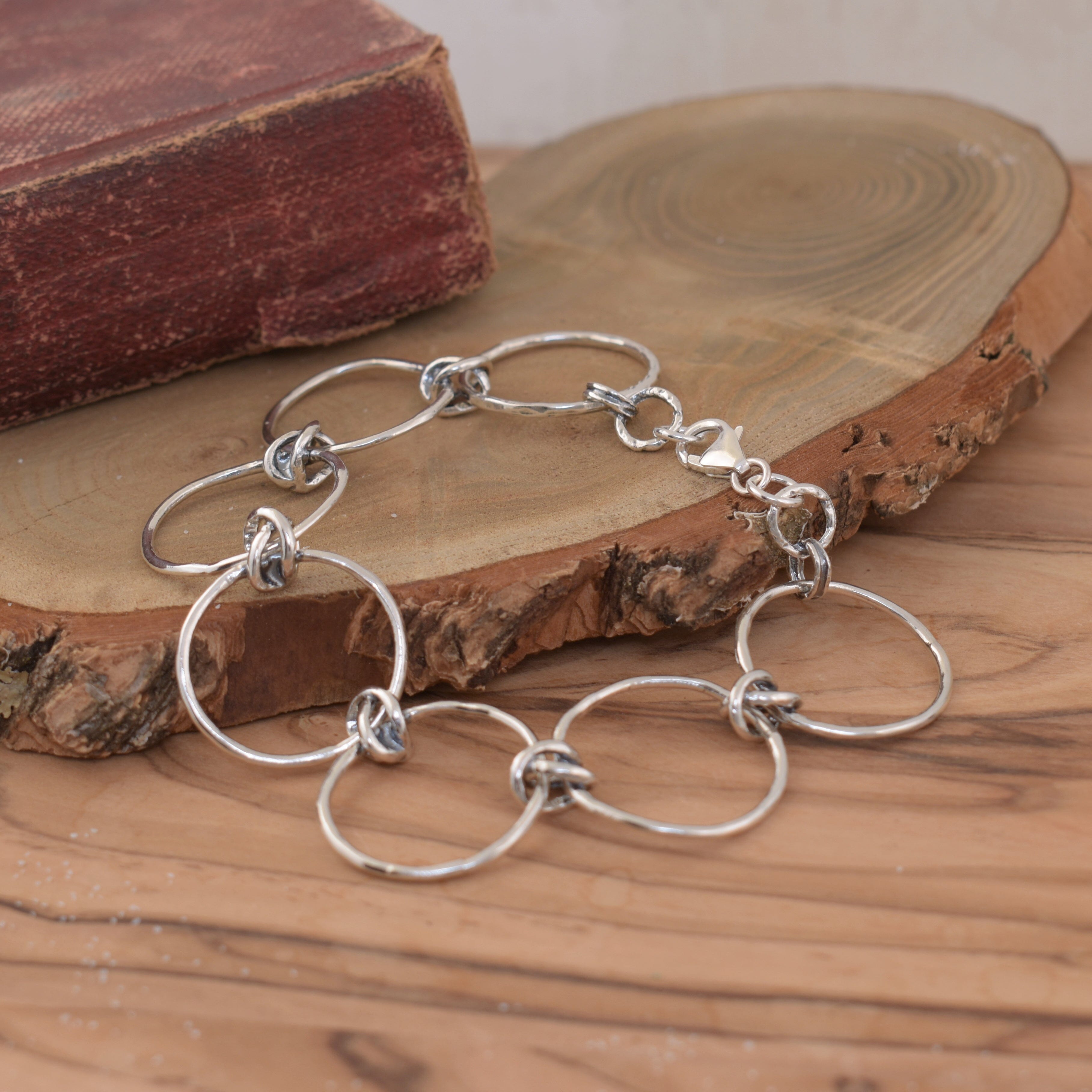 organic open circle bracelet linked together with knot design in sterling silver