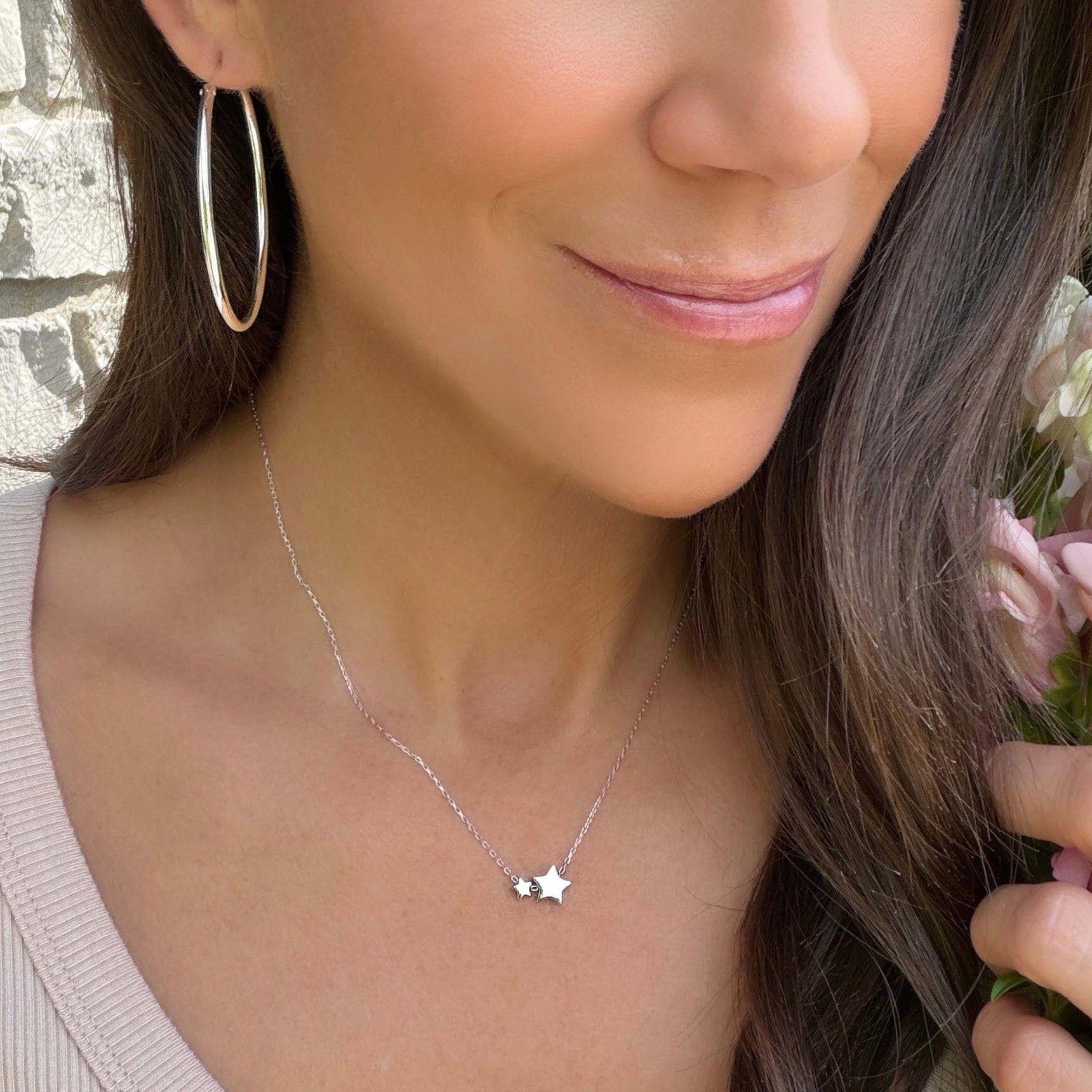 delicate silver necklace featuring two small star pendants