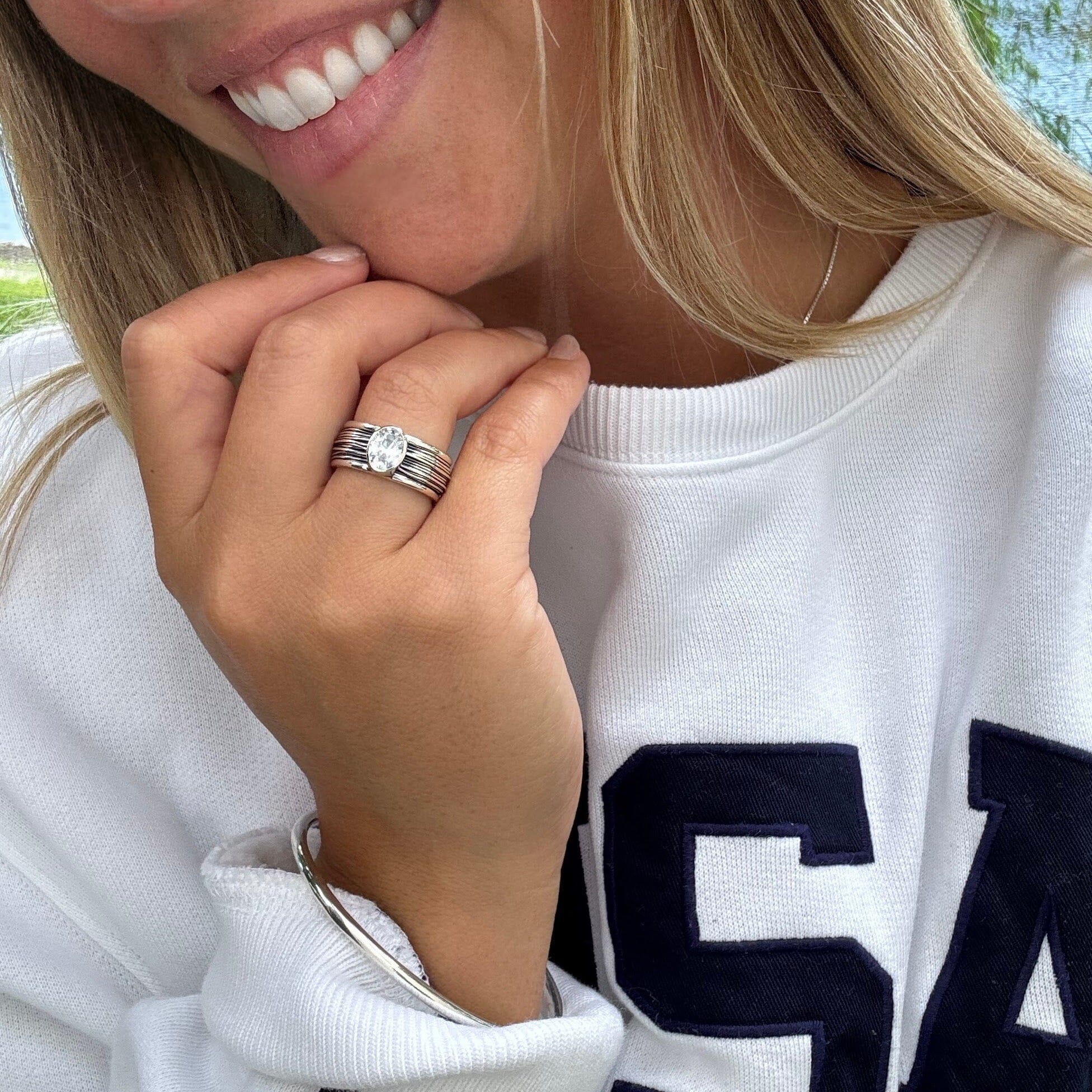 oval cubic zirconia bezel-set in a medium-width sterling silver band