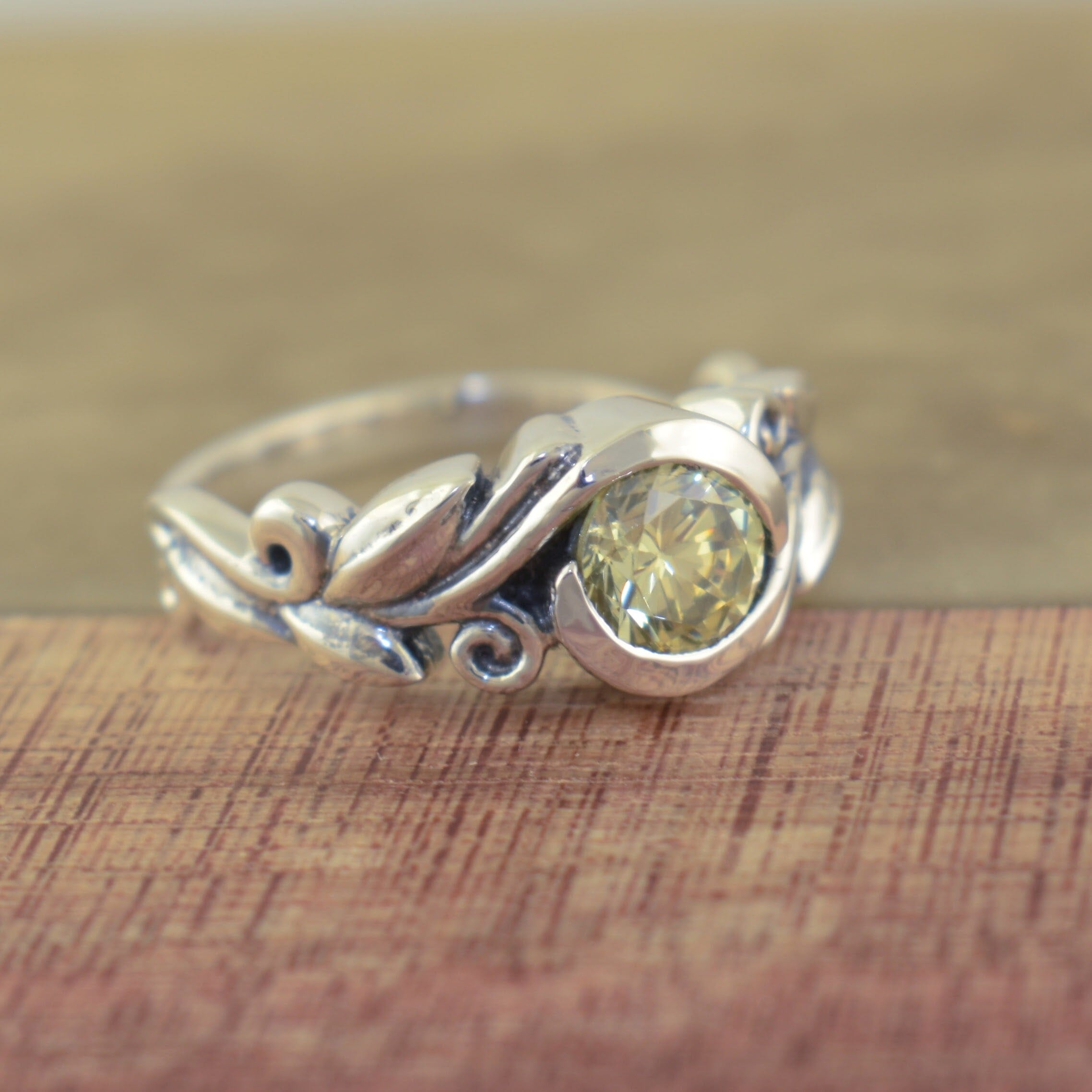 silver ring with a vine and leaf designed band
