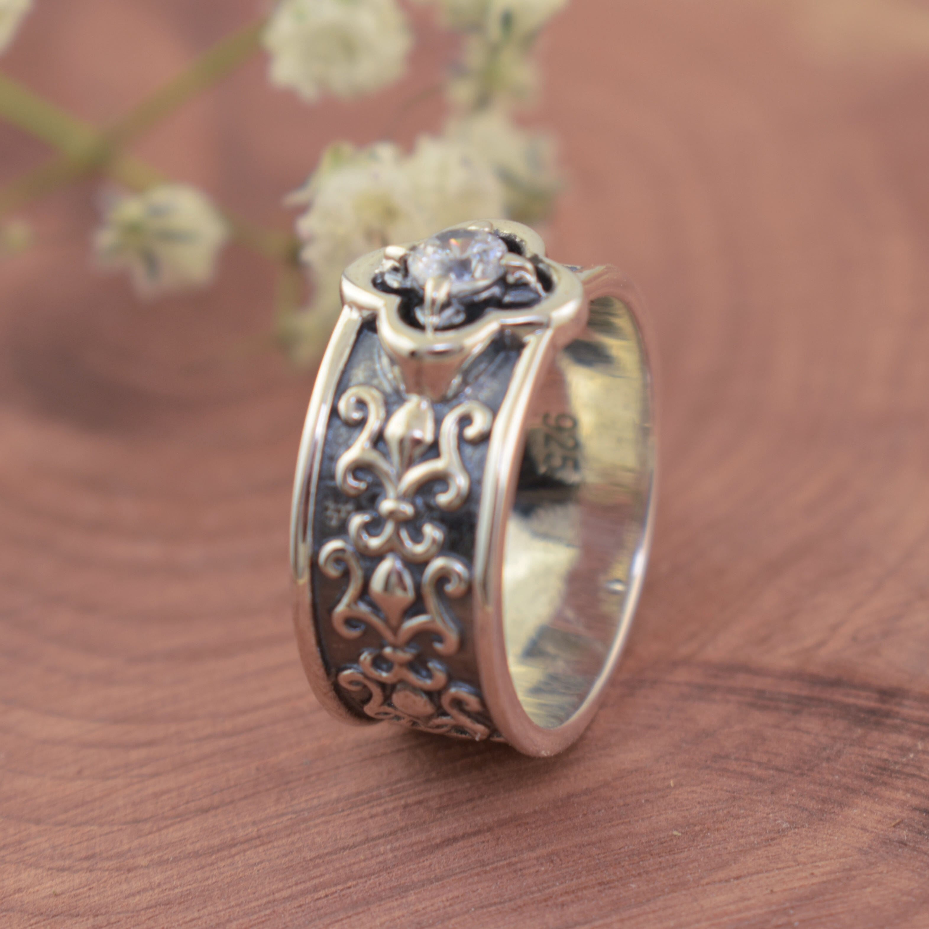 wide vintage cz ring with an oxidized band and high polished swirl designs