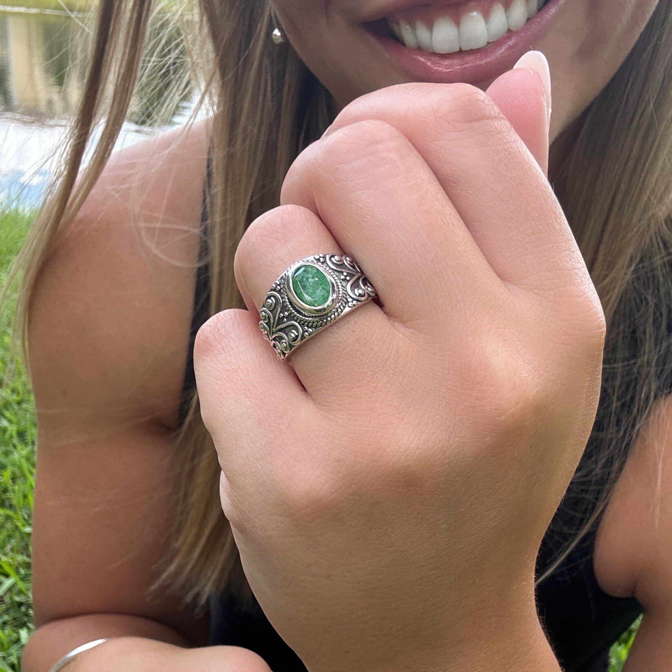 green gemstone ring with a decorative sterling silver band