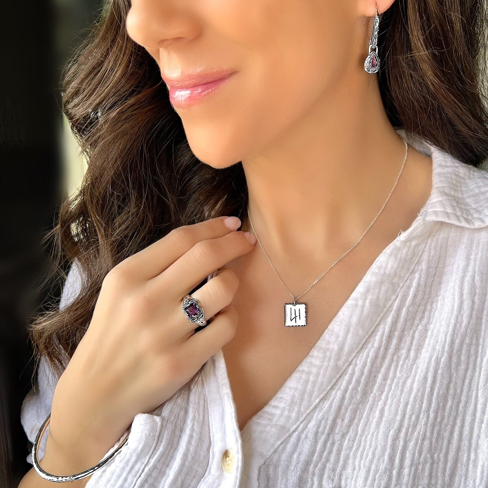 handcrafted sterling silver ring with a square cut Amethyst stone prong set