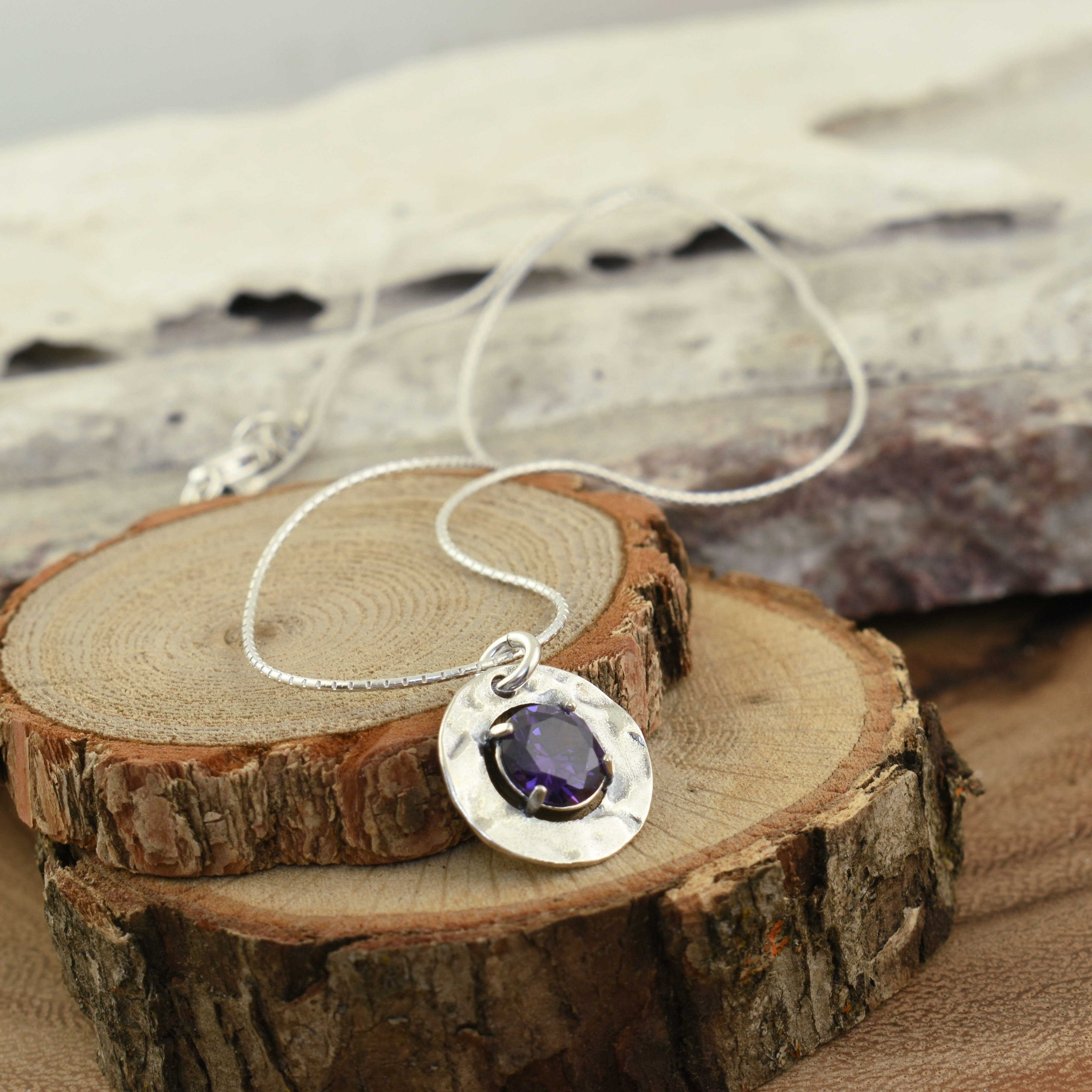 silver necklace featuring round lavender CZ