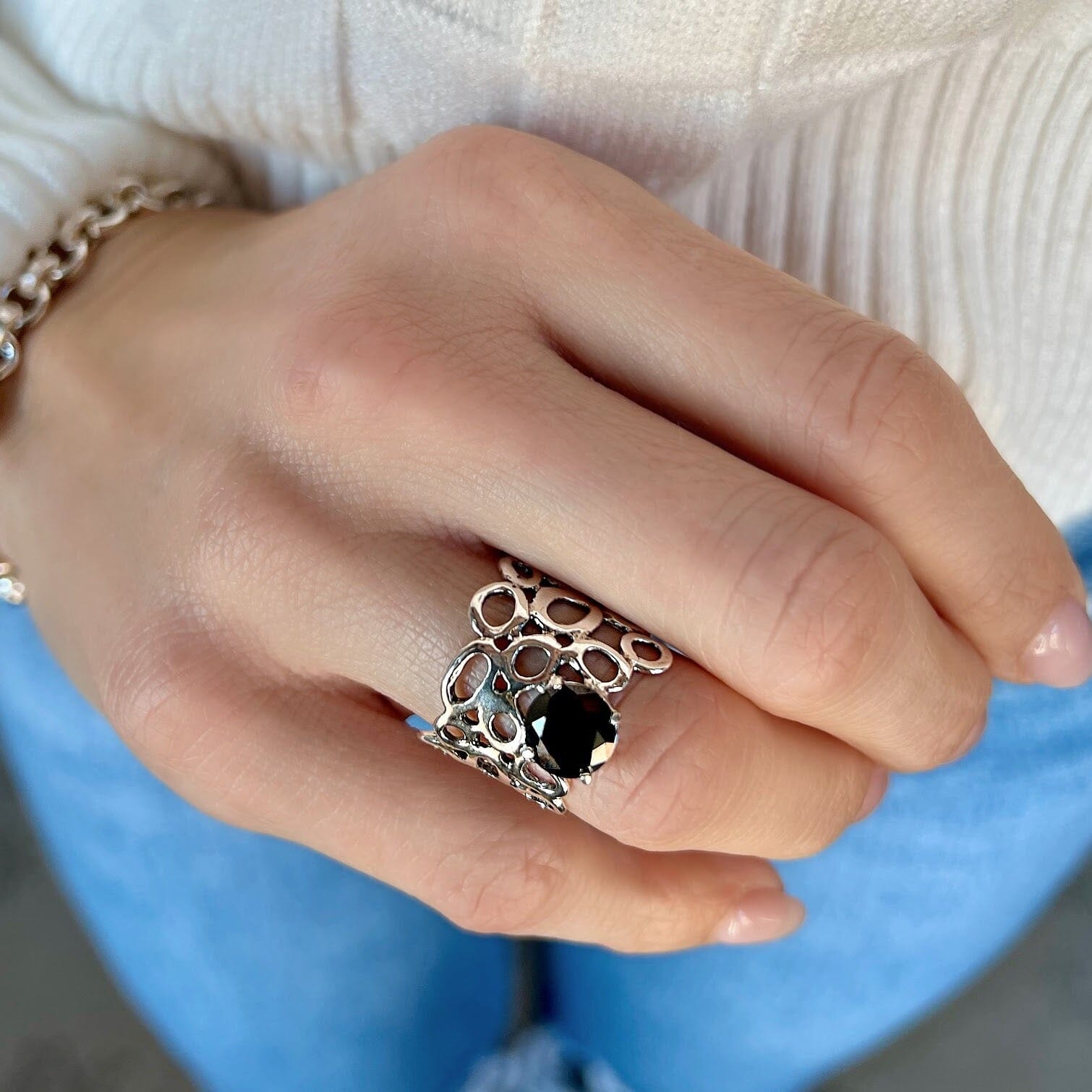 unique sterling silver ring featuring prong set black cz