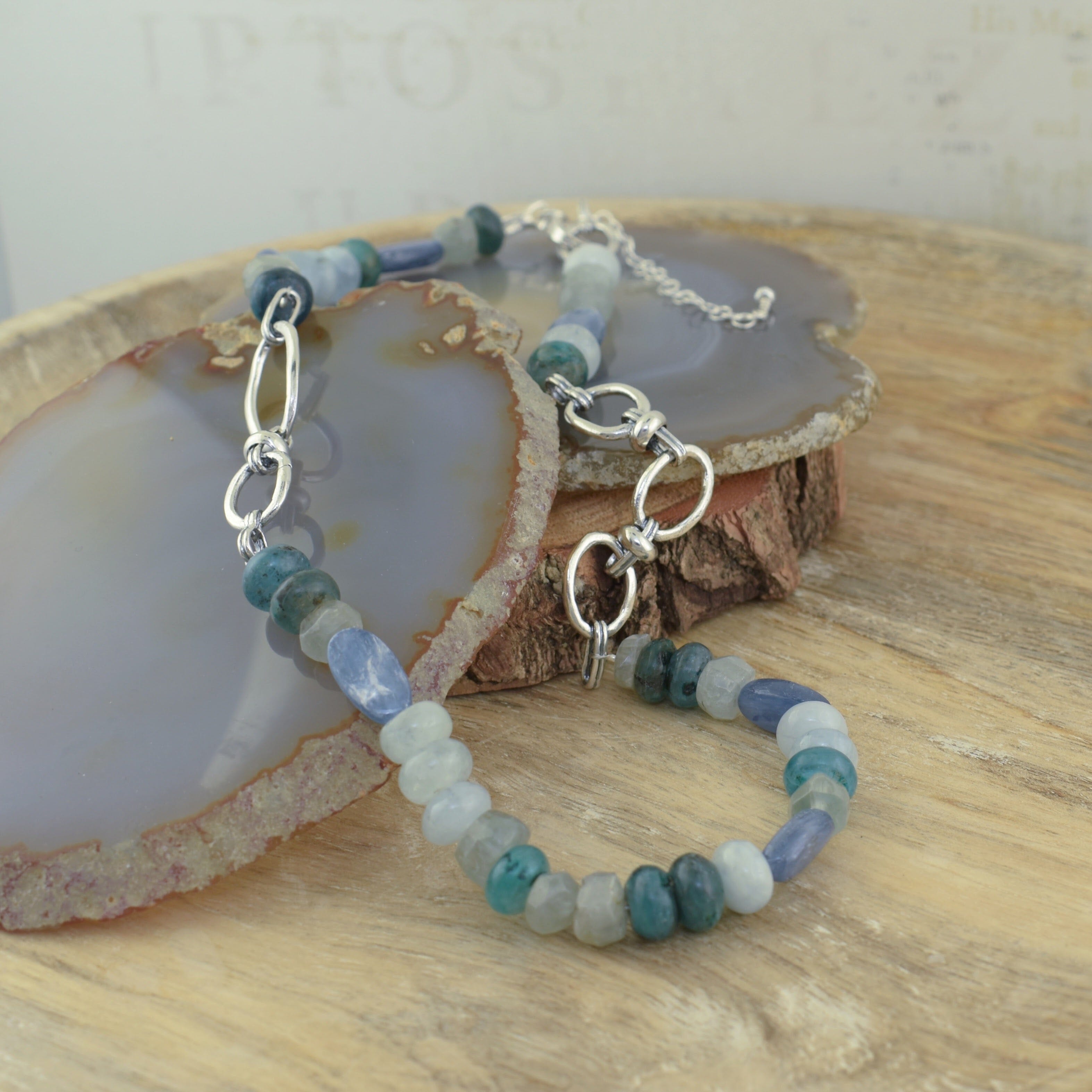 ocean hue Voyager necklace featuring organic silver links and various aquamarine, hematite, and kyanite beads