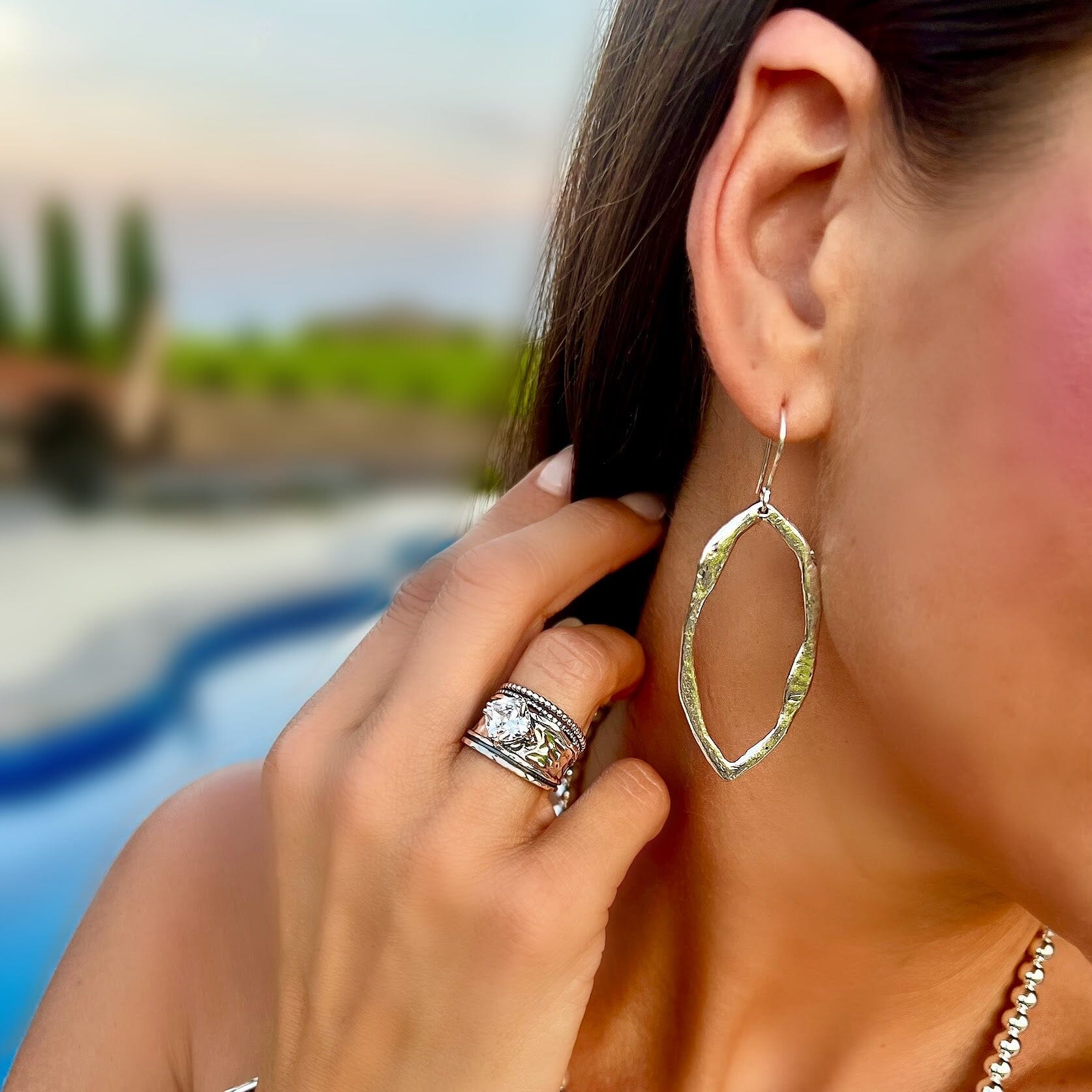 organic shaped earrings hook backs paired with the grandstand ring