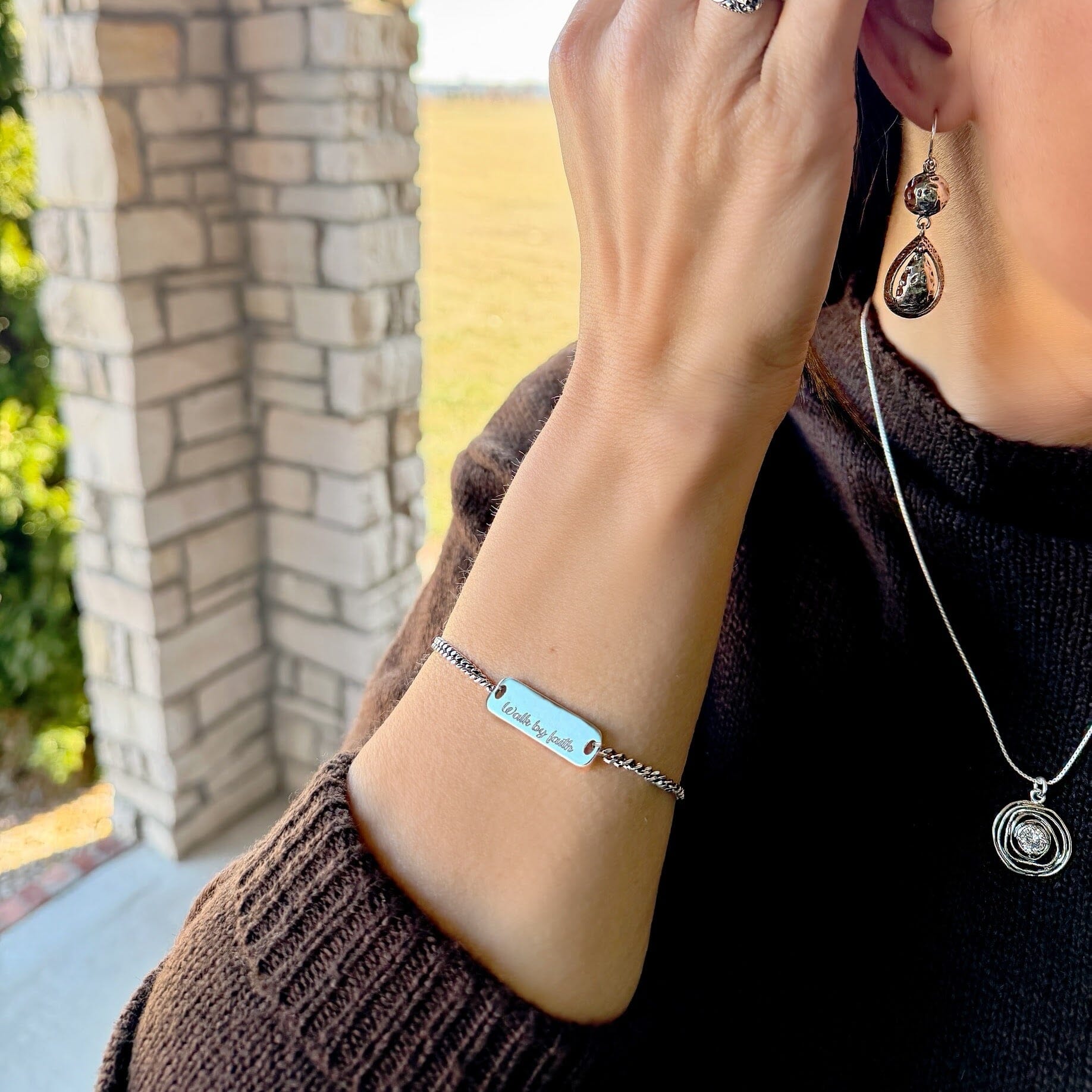 silver bar bracelet stamped with "walk by faith"