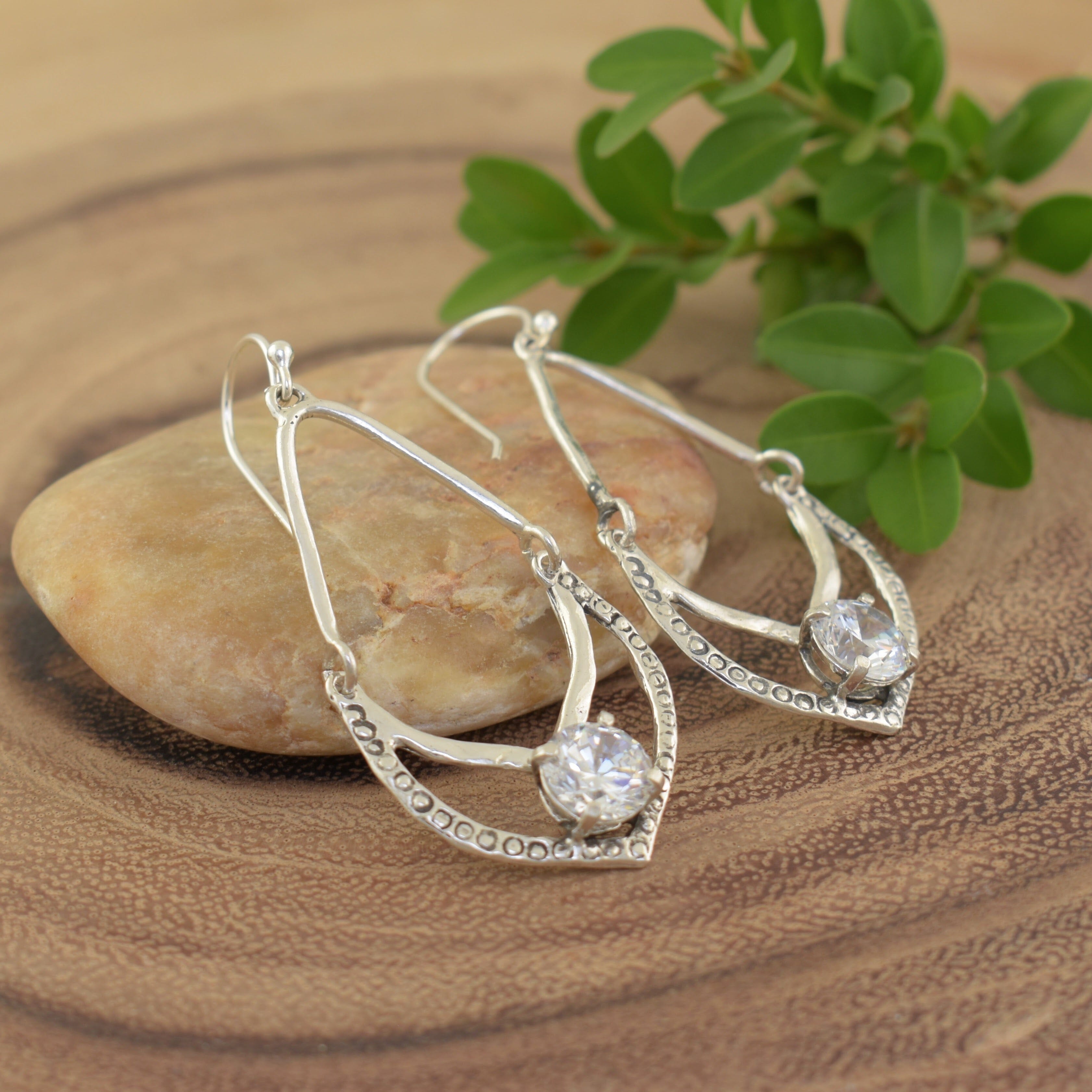 Sterling silver drop earrings with a prong set clear stone