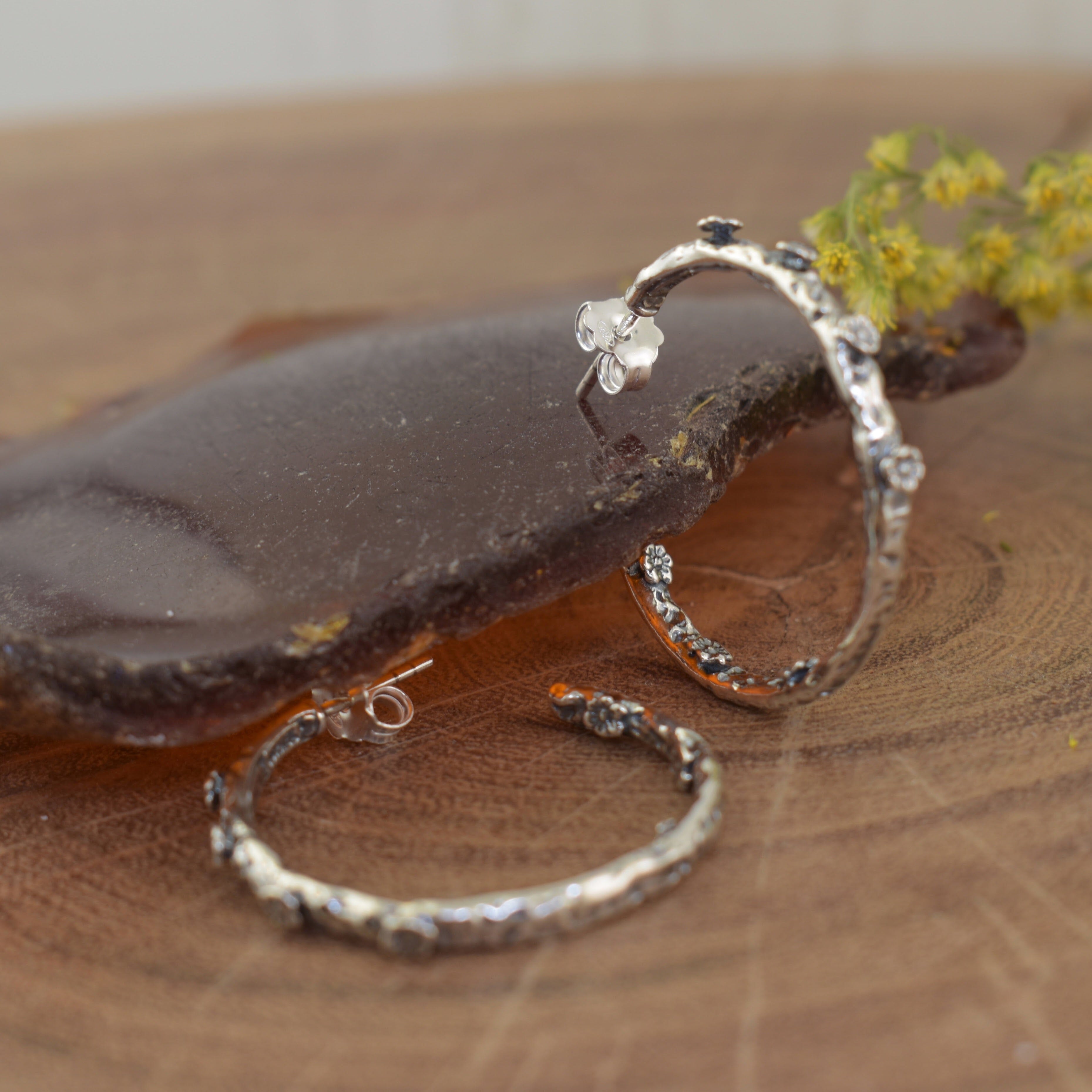 thin hoop earrings with flower details