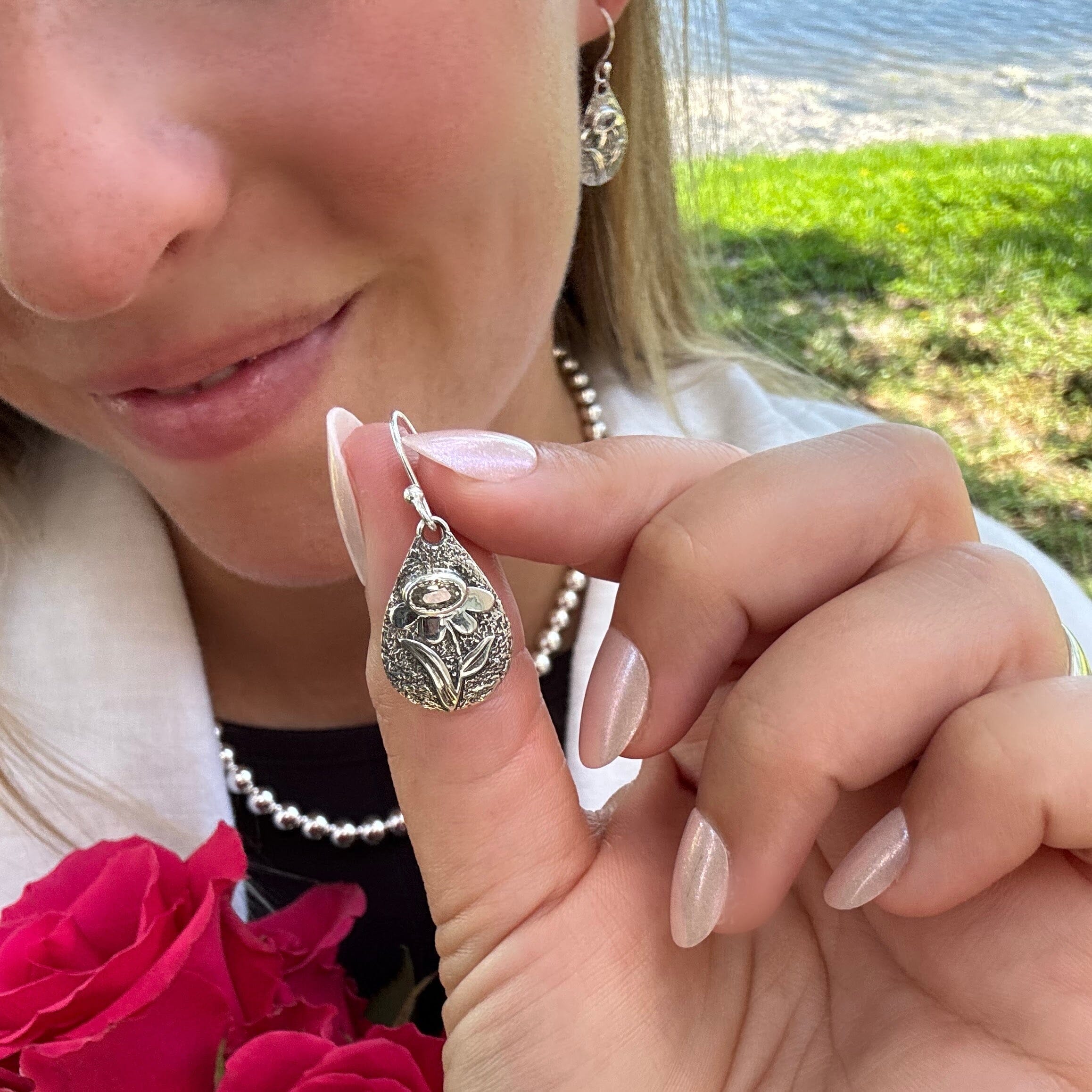 featuring a raised flower and faceted stone