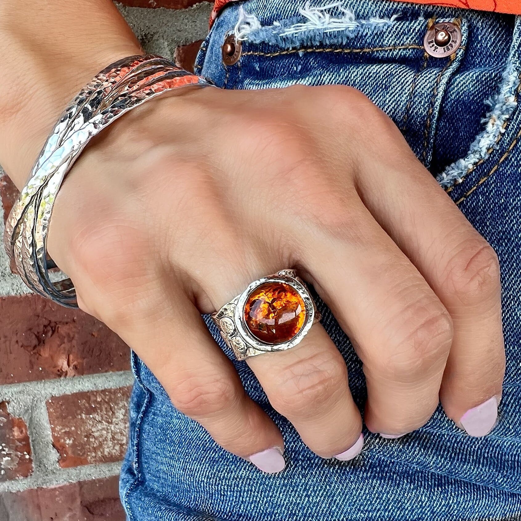 synthetic amber ring paired with a hammered bangle bracelet
