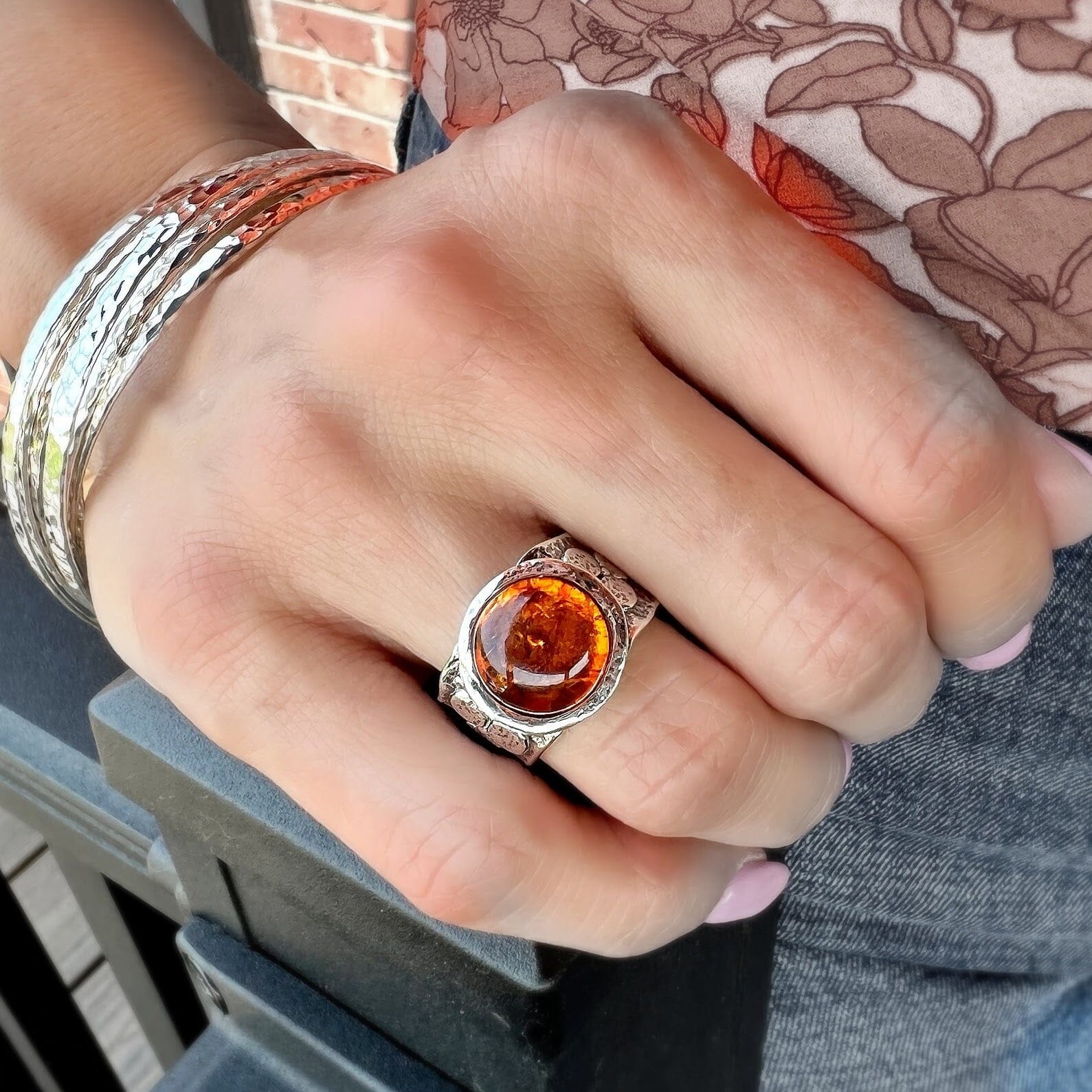 chunky floral ring featuring a round synthetic amber stone