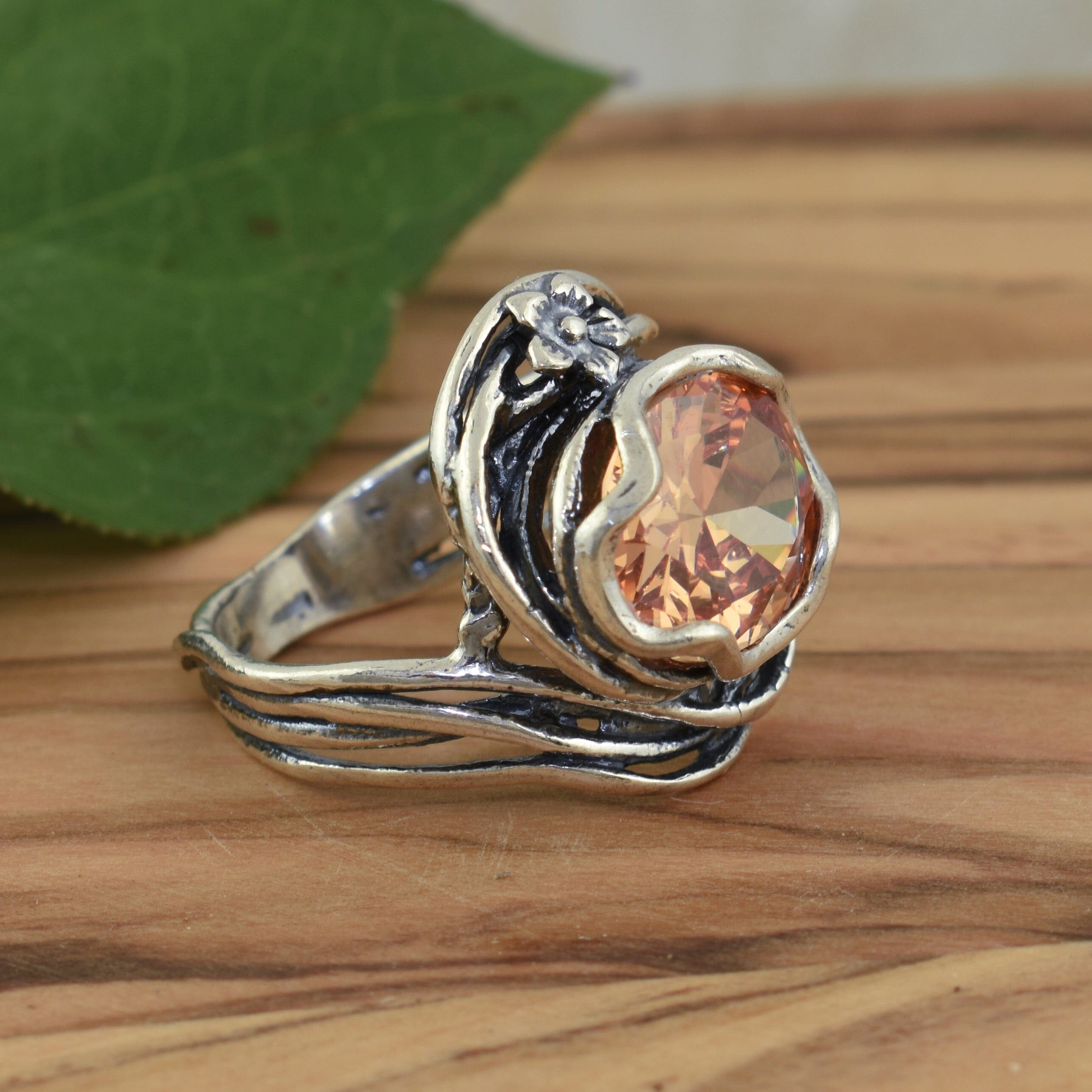 chunky silver floral ring with a peach-ish cz center