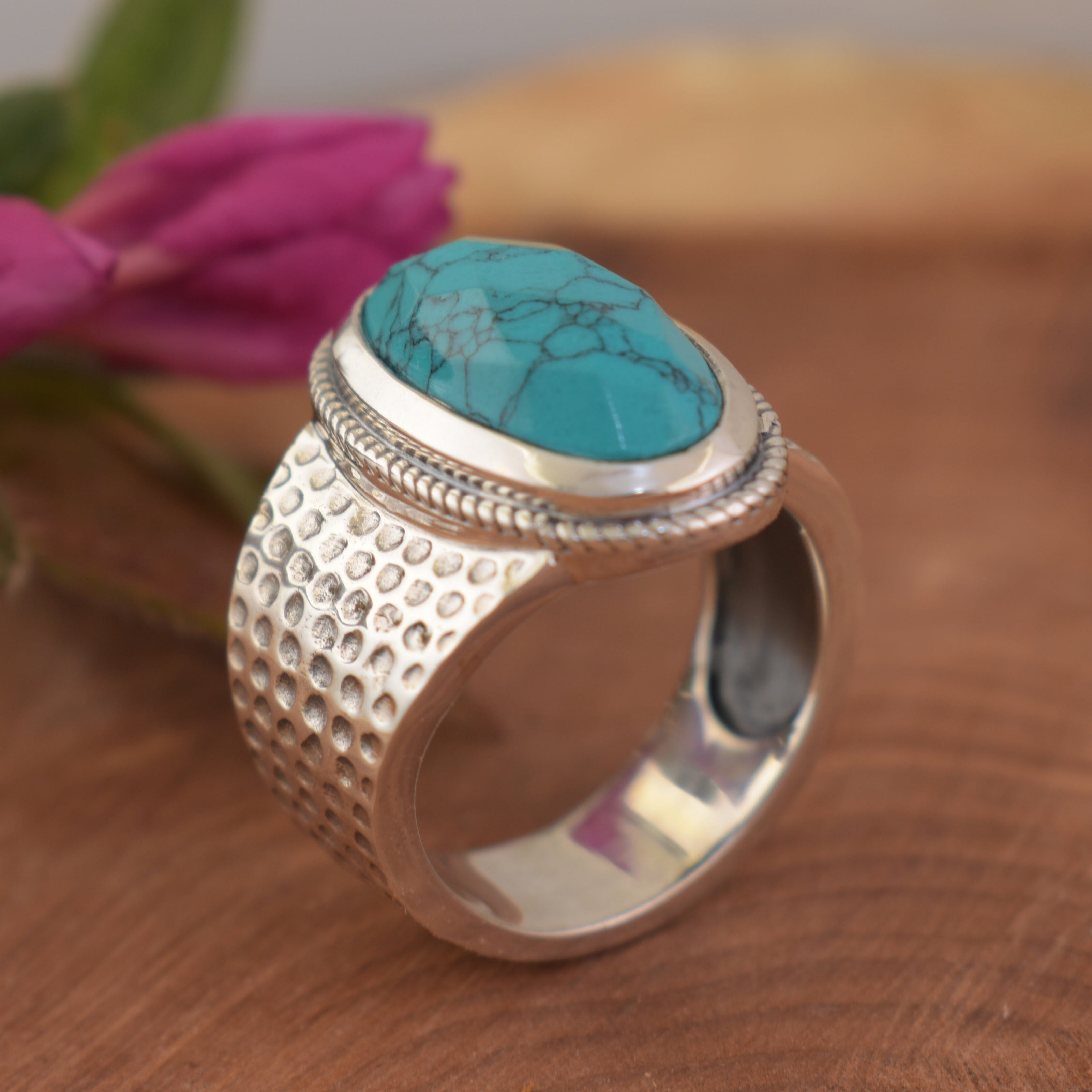 silver Western-style ring featuring a large oval turquoise stone