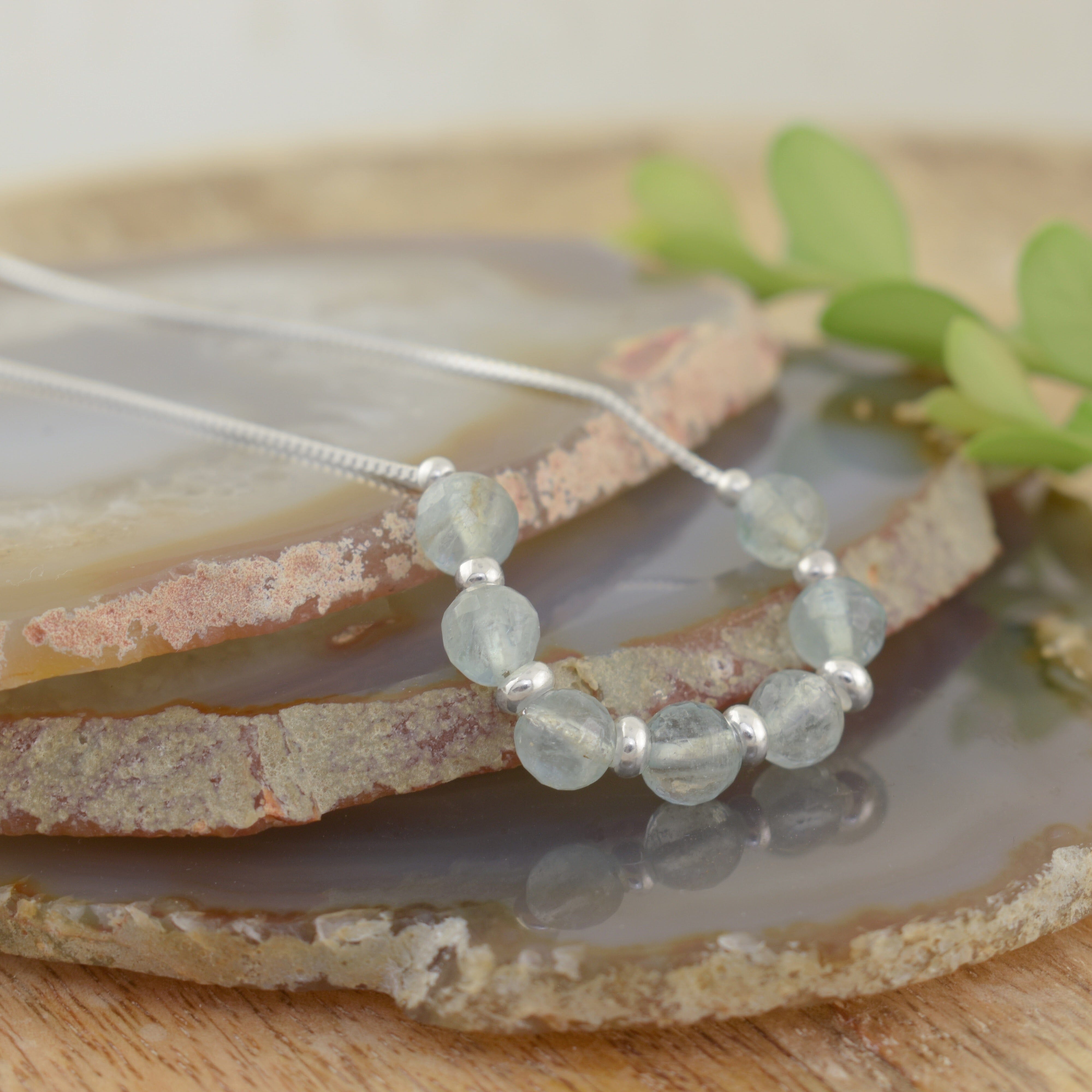 A sterling silver chain with pale blue-green beads, with sterling silver spacer beads